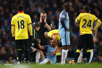 MANCHESTER, ENGLAND - DECEMBER 14: Ilkay Gundogan (C) of Manchester City receives medical treatment before being substituted due to an injury during the Premier League match between Manchester City and Watford at Etihad Stadium on December 14, 2016 in Man