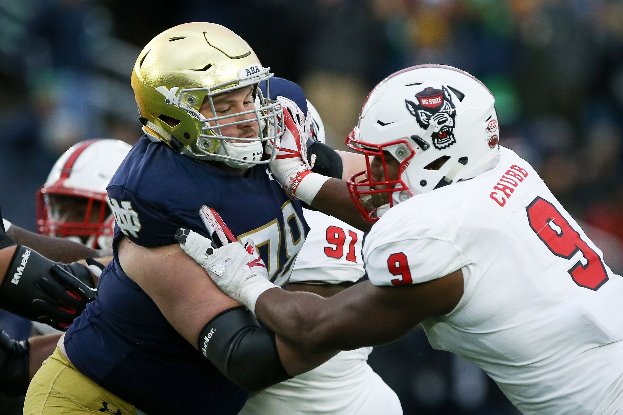 SOUTH BEND, IN - OCTOBER 28:  Tommy Kraemer #78 of the Notre Dame Fighting Irish blocks against Bradley Chubb #9 of the North Carolina State Wolfpack in the second quarter at Notre Dame Stadium on October 28, 2017 in South Bend, Indiana. (Photo by Dylan B