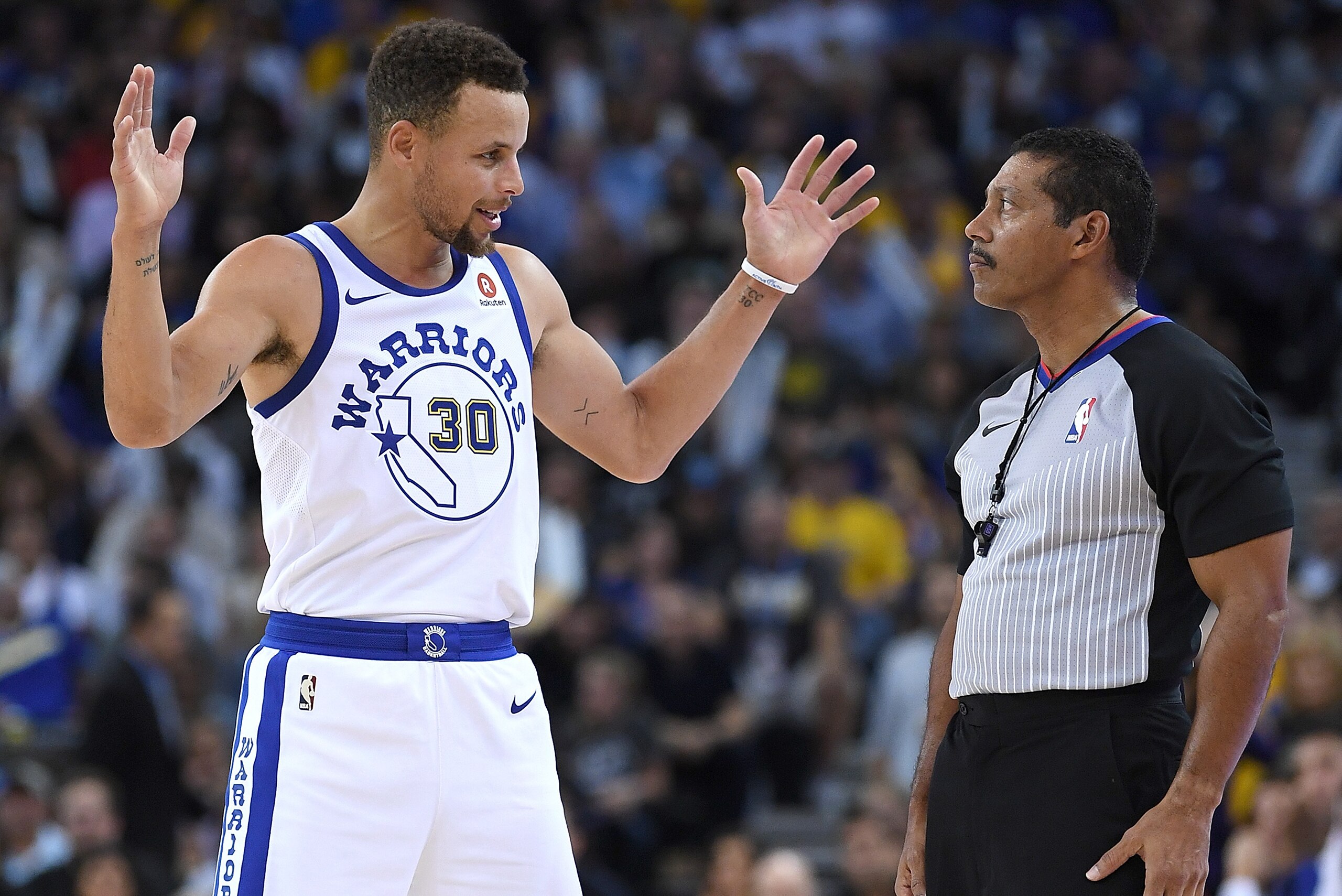 OAKLAND, CA - OCTOBER 27:  Stephen Curry #30 of the Golden State Warriors talks with referee Bill Kennedy #55 about a foul call made during an NBA basketball game against the Washington Wizards at ORACLE Arena on October 27, 2017 in Oakland, California. N