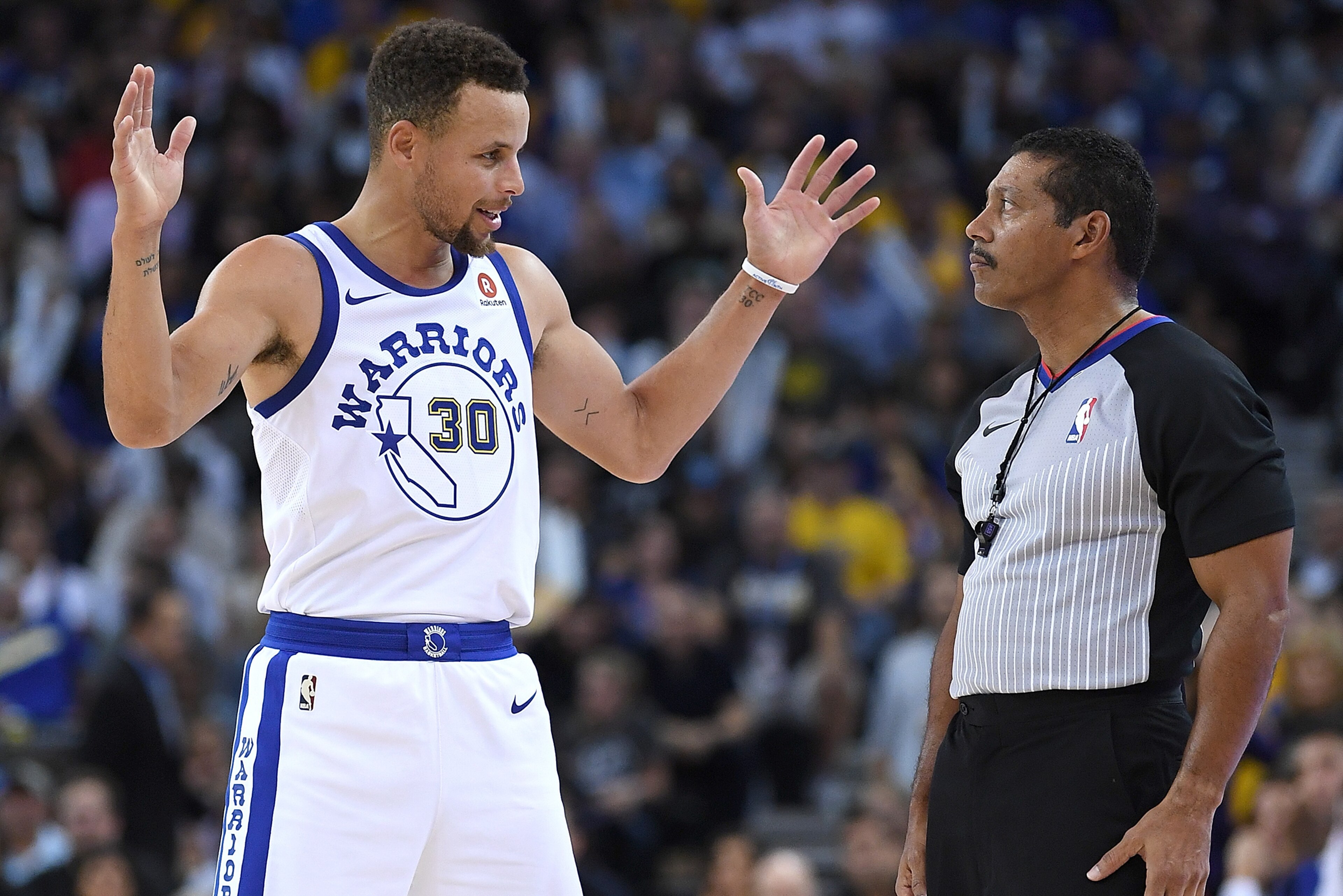 OAKLAND, CA - OCTOBER 27:  Stephen Curry #30 of the Golden State Warriors talks with referee Bill Kennedy #55 about a foul call made during an NBA basketball game against the Washington Wizards at ORACLE Arena on October 27, 2017 in Oakland, California. N