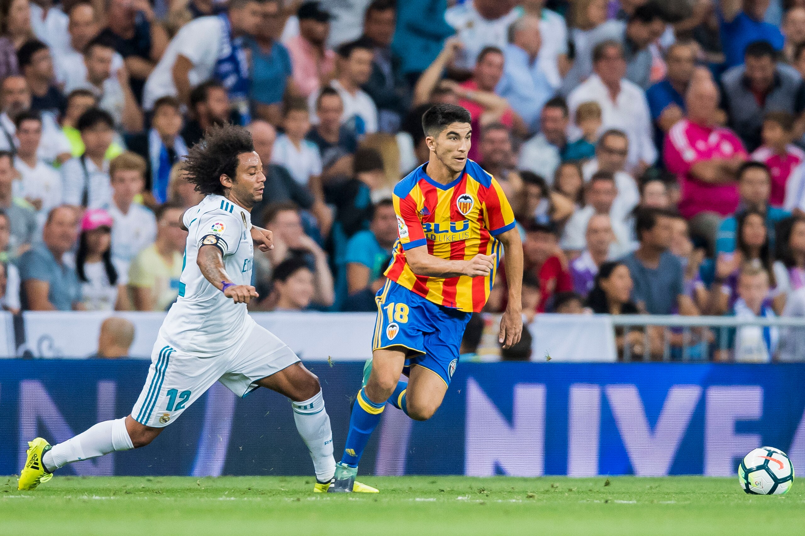 MADRID, SPAIN - AUGUST 27: Carlos Soler Barragan (r) of Valencia CF is tackled by Marcelo Vieira Da Silva of Real Madrid during their La Liga 2017-18 match between Real Madrid and Valencia CF at the Estadio Santiago Bernabeu on 27 August 2017 in Madrid, S