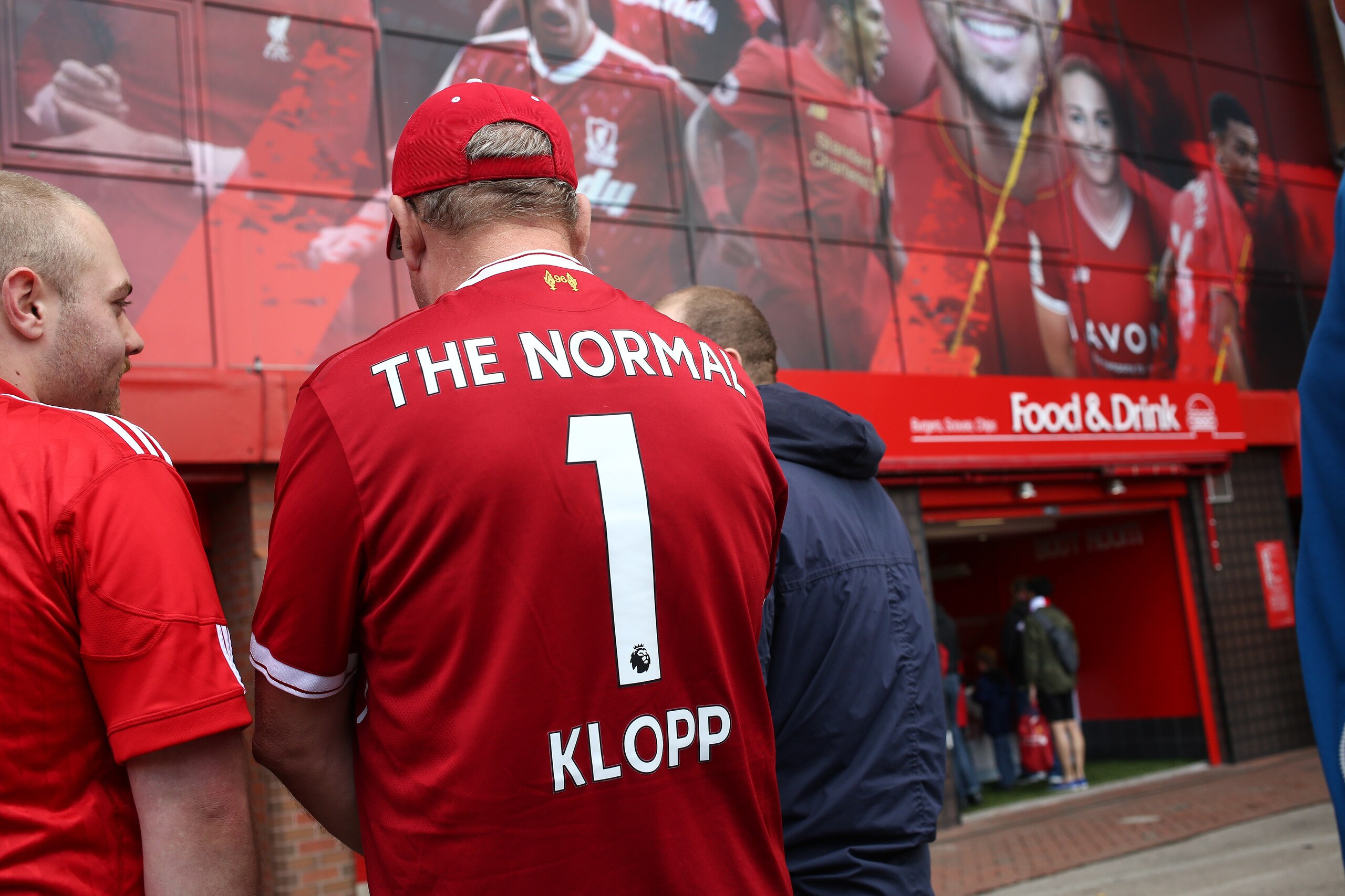 LIVERPOOL, ENGLAND - AUGUST 19: A Liverpool fans wears a shirt that reads The Normal 1 Klopp on the back prior to the Premier League match between Liverpool and Crystal Palace at Anfield on August 19, 2017 in Liverpool, England. (Photo by Robbie Jay Barra LIVERPOOL, ENGLAND - AUGUST 19: A Liverpool fans wears a shirt that reads The Normal 1 Klopp on the back prior to the Premier League match between Liverpool and Crystal Palace at Anfield on August 19, 2017 in Liverpool, England. (Photo by Robbie Jay Barra