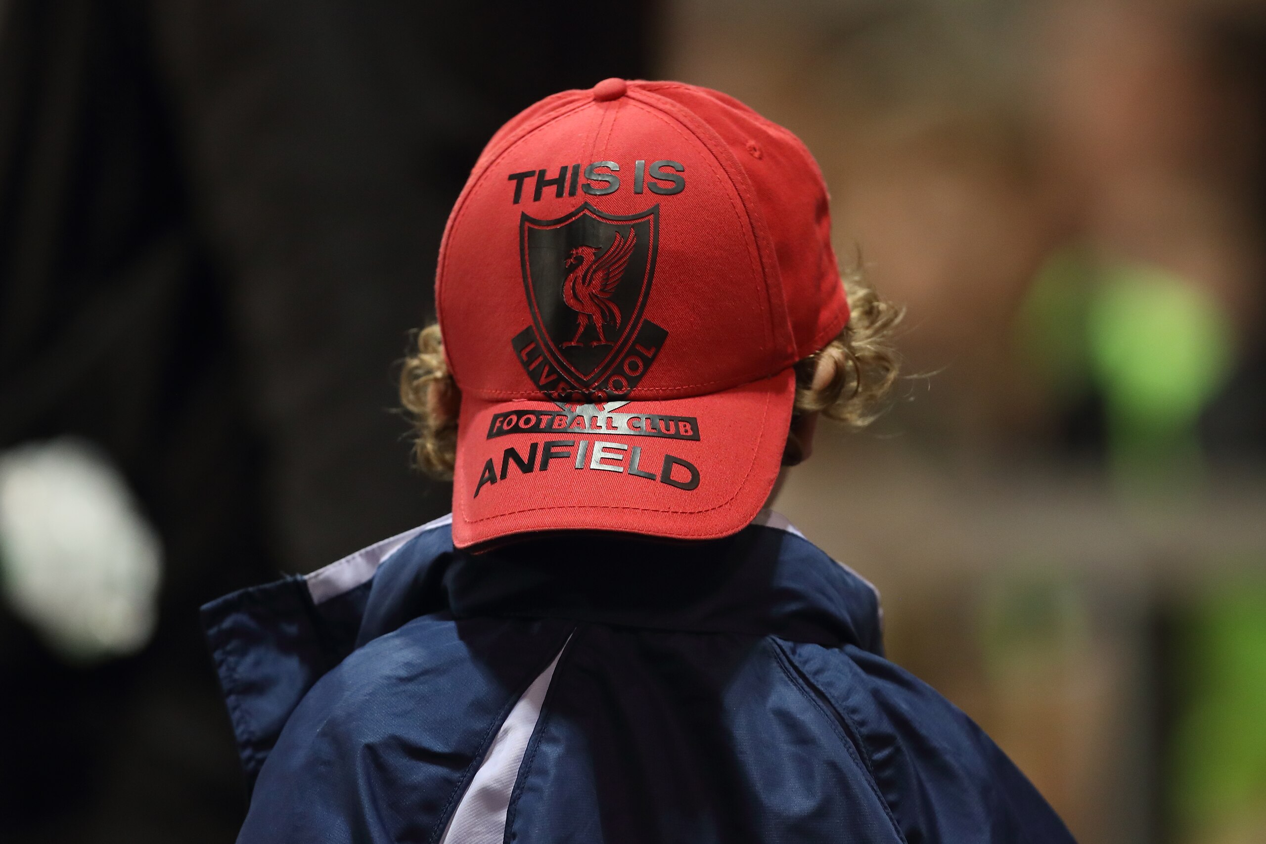 LEIGH, GREATER MANCHESTER - OCTOBER 23: A young fan of Liverpool wears a This Is Anfield hat during the Premier League 2 fixture between Manchester United and Liverpool at Leigh Sports Village on October 23, 2017 in Leigh, Greater Manchester. (Photo by Ro LEIGH, GREATER MANCHESTER - OCTOBER 23: A young fan of Liverpool wears a This Is Anfield hat during the Premier League 2 fixture between Manchester United and Liverpool at Leigh Sports Village on October 23, 2017 in Leigh, Greater Manchester. (Photo by Ro