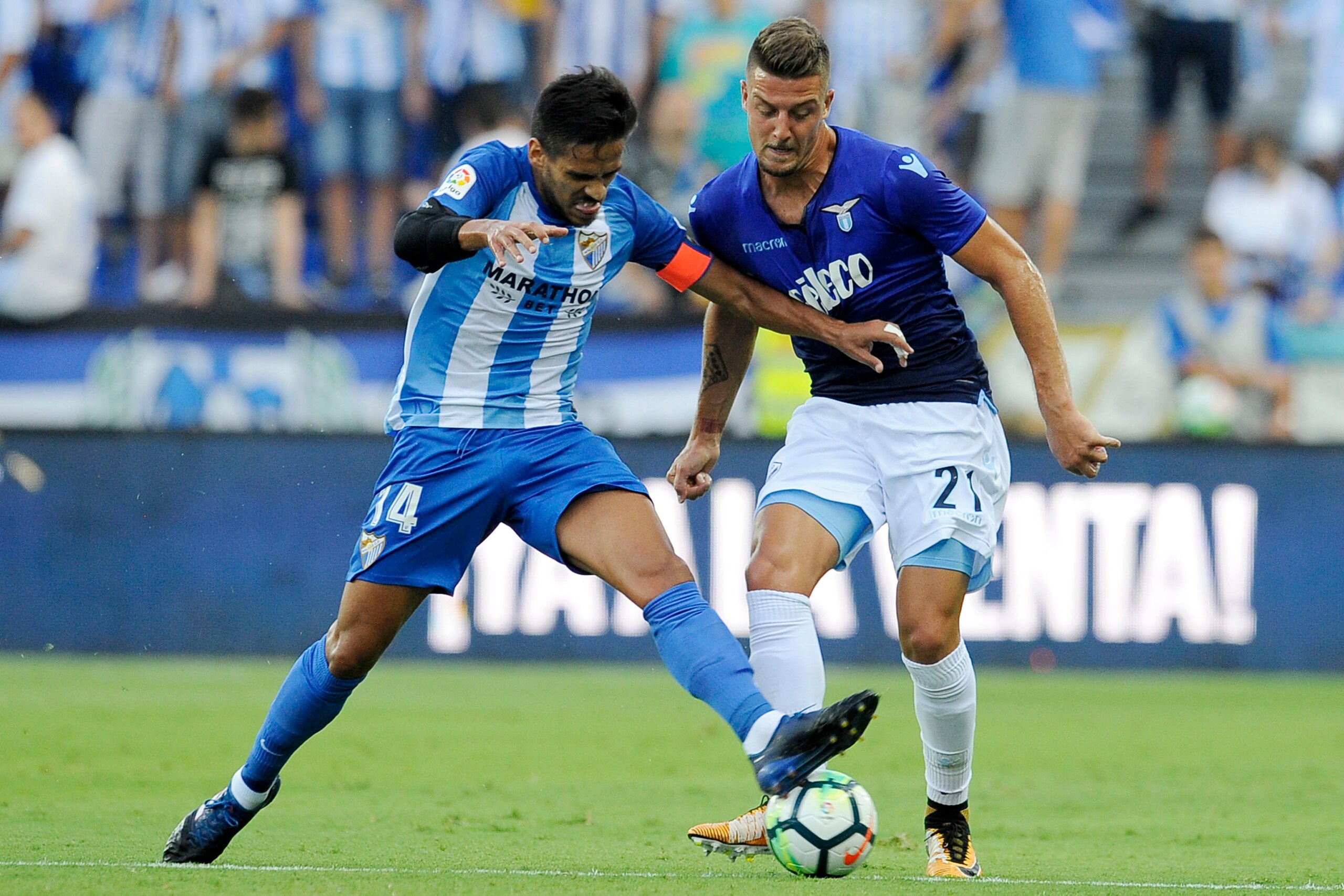 MALAGA, MALAGA - AUGUST 05: Sergej Milinkovic Savic of SS Lazio compete for the ball with Recio of Malaga CF during the Pre-Season Friendly match between Malaga CF and SS Lazio at Estadio La Rosaleda on August 5, 2017 in Malaga, Spain. (Photo by Marco R MALAGA, MALAGA - AUGUST 05: Sergej Milinkovic Savic of SS Lazio compete for the ball with Recio of Malaga CF during the Pre-Season Friendly match between Malaga CF and SS Lazio at Estadio La Rosaleda on August 5, 2017 in Malaga, Spain. (Photo by Marco R