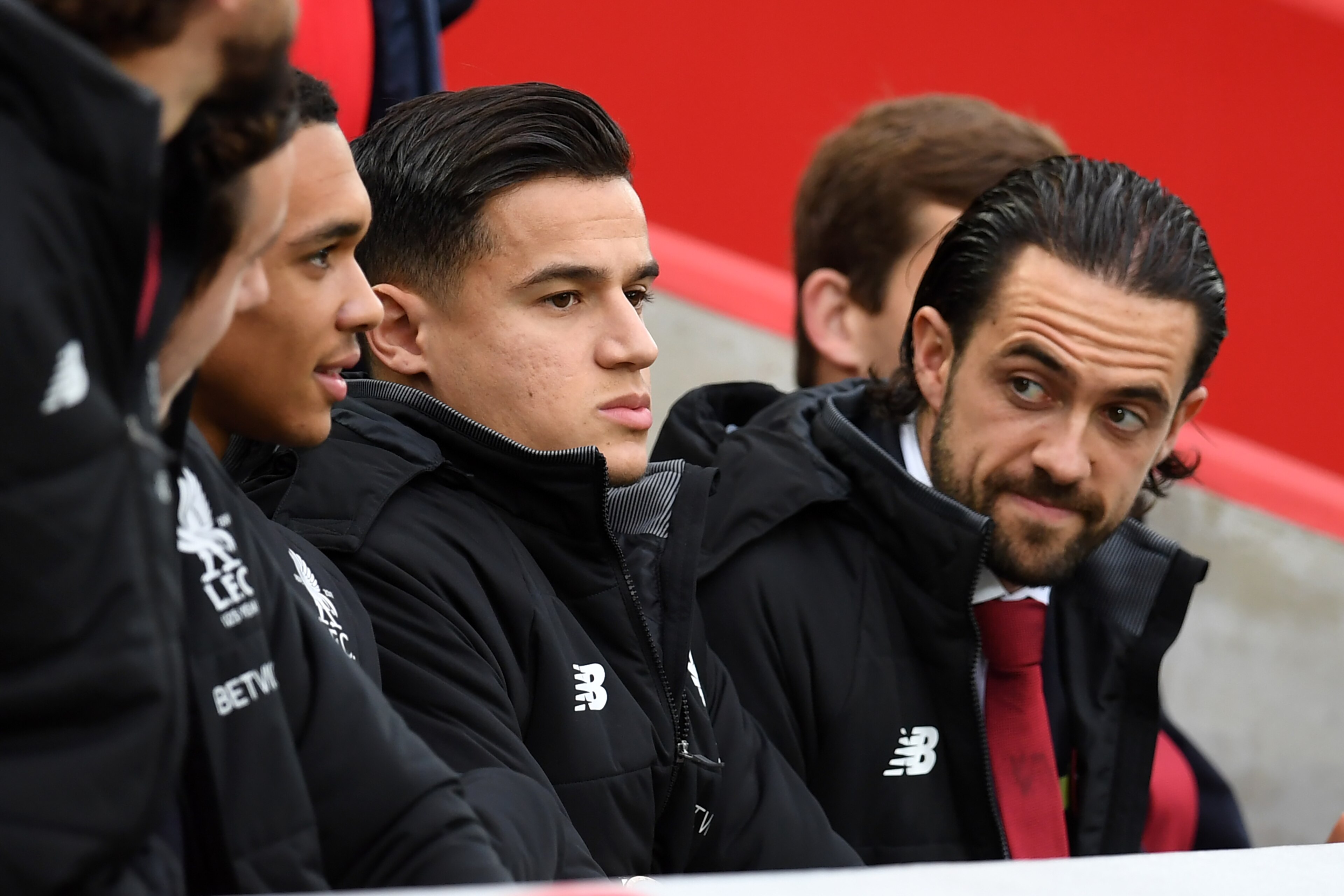 Liverpool's Brazilian midfielder Philippe Coutinho (C) and Liverpool's English striker Danny Ings (R) take their seats for the English Premier League football match between Liverpool and Huddersfield Town at Anfield in Liverpool, north west England on Oct