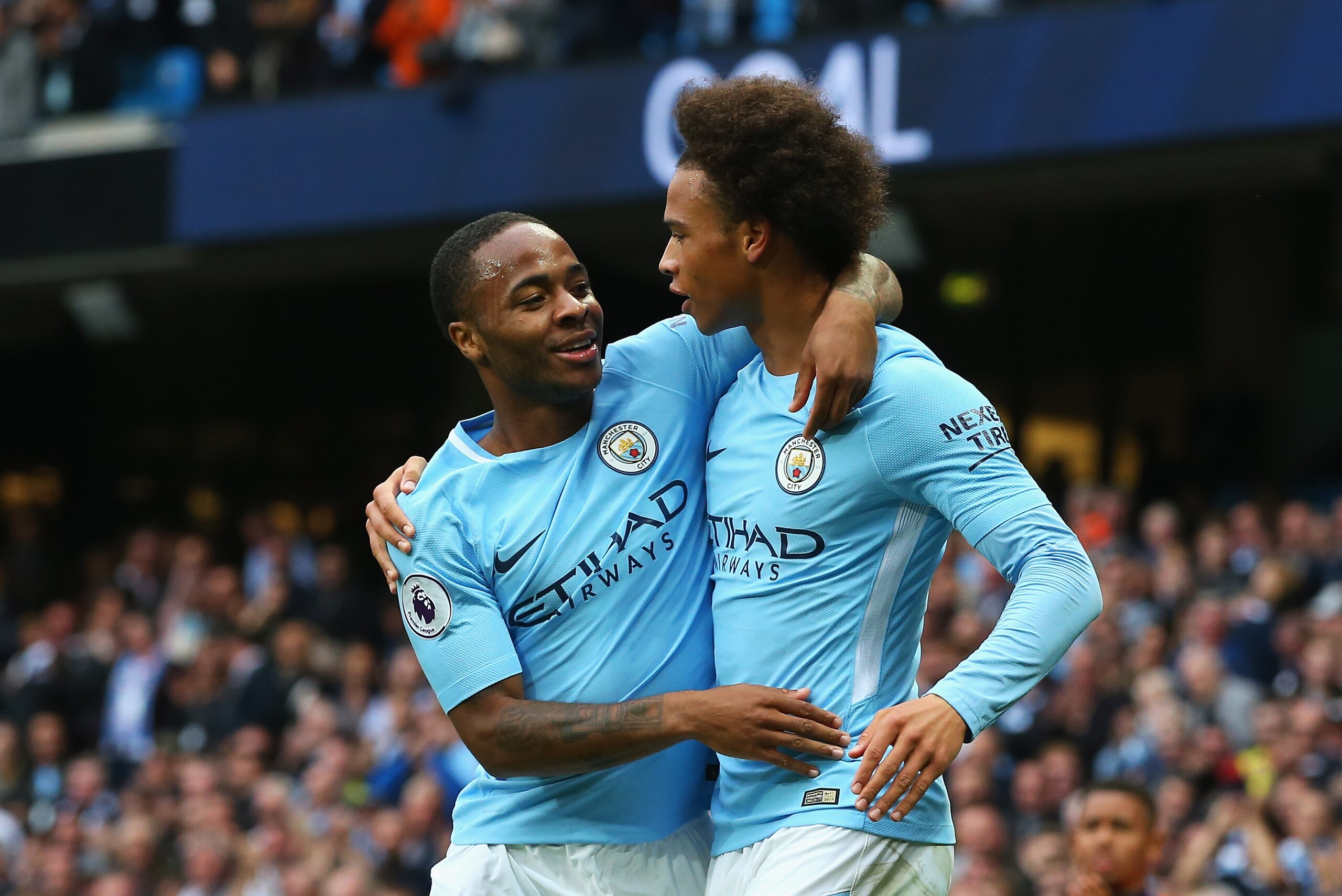 MANCHESTER, ENGLAND - SEPTEMBER 23:  Raheem Sterling (L) of Manchester City celebrates scoring his sides second goal with his team mate Leroy Sane (R) during the Premier League match between Manchester City and Crystal Palace at Etihad Stadium on Septembe