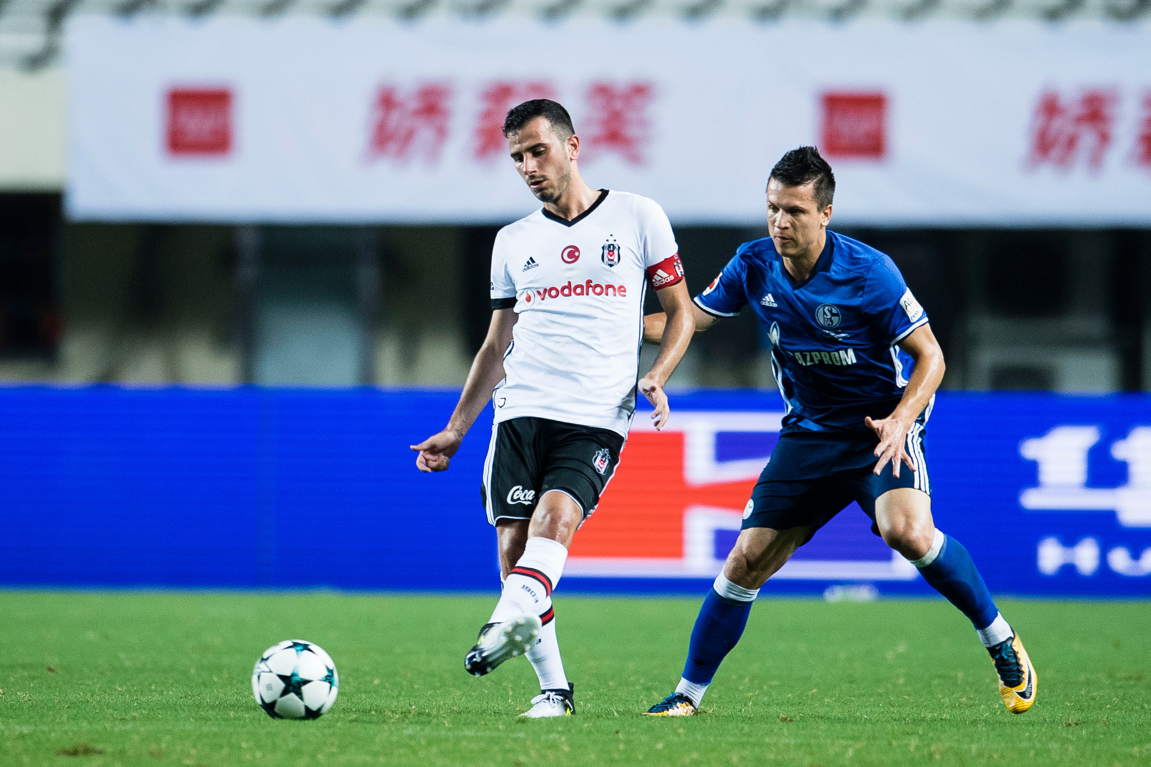 ZHUHAI, CHINA - JULY 19: Besiktas Istambul Midfielder Oguzhan Ozyakup (L) plays against FC Schalke Midfielder Yevhen Konoplyanka (R) during the Friendly Football Matches Summer 2017 between FC Schalke 04 Vs Besiktas Istanbul at Zhuhai Sport Center Stadium ZHUHAI, CHINA - JULY 19: Besiktas Istambul Midfielder Oguzhan Ozyakup (L) plays against FC Schalke Midfielder Yevhen Konoplyanka (R) during the Friendly Football Matches Summer 2017 between FC Schalke 04 Vs Besiktas Istanbul at Zhuhai Sport Center Stadium