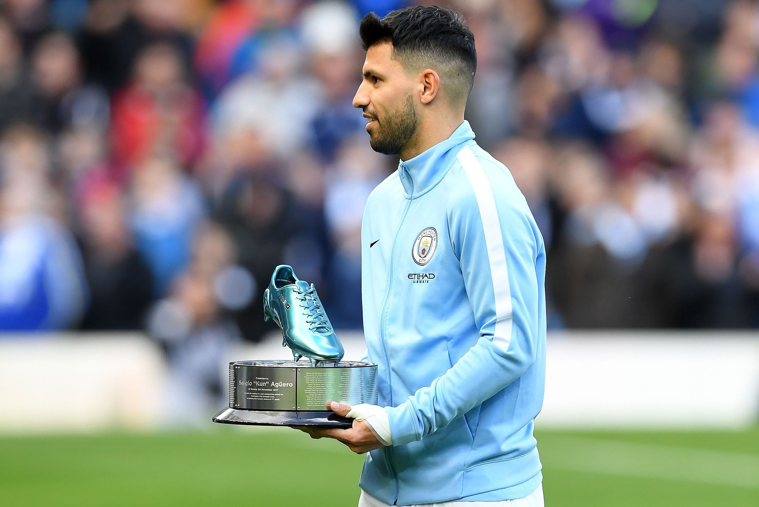 Manchester City's Argentinian striker Sergio Aguero is awarded a trophy for being Manchester City's all-time leading goal scorer, ahead of the English Premier League football match between Manchester City and Arsenal at the Etihad Stadium in Manchester, n