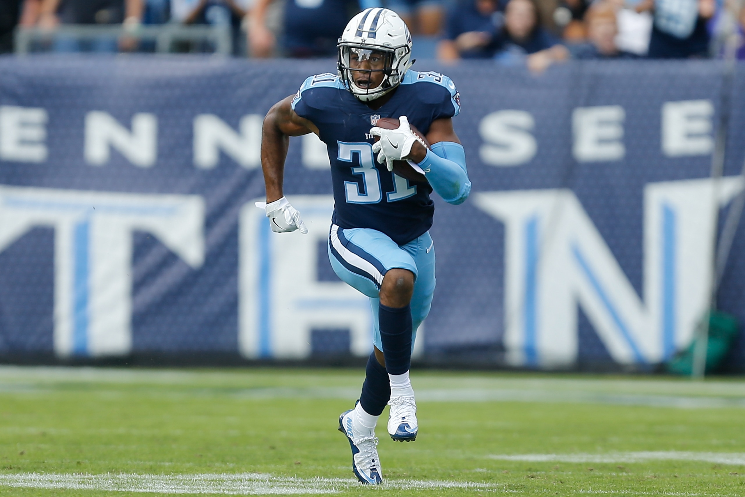 NASHVILLE, TN - NOVEMBER 05:  Kevin Byard #31 of the Tennessee Titans runs with the ball after a interception against the Baltimore Ravens at Nissan Stadium on November 5, 2017 in Nashville, Tennessee.  (Photo by Michael Reaves/Getty Images)