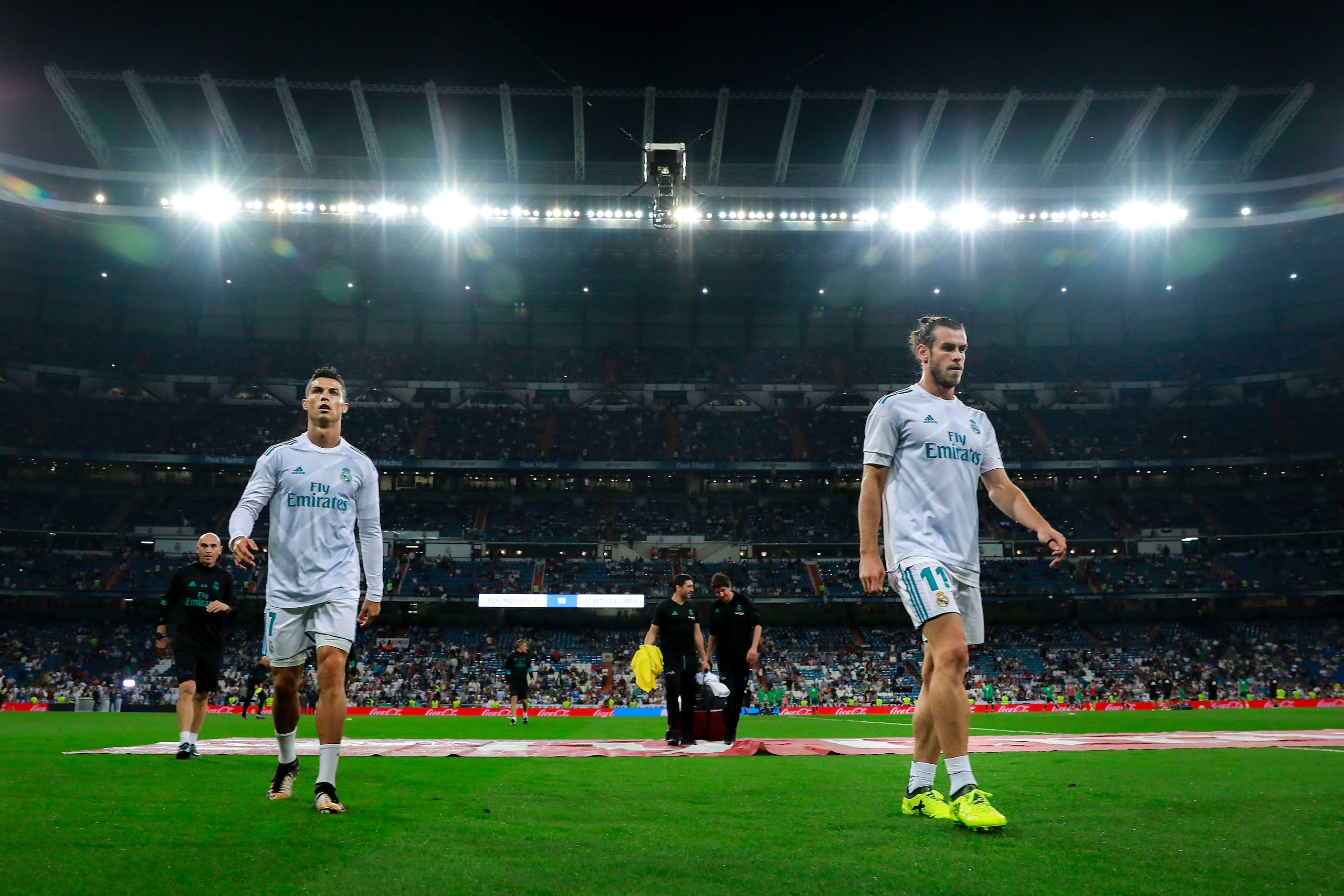 MADRID, SPAIN - SEPTEMBER 20:  Cristiano Ronaldo (L) of Real Madrid CF and his teammate Gareth Bale (R) leave the pitch after their team's warming-up before the La Liga match between Real Madrid CF and Real Betis Balompie at Estadio Santiago Bernabeu on S