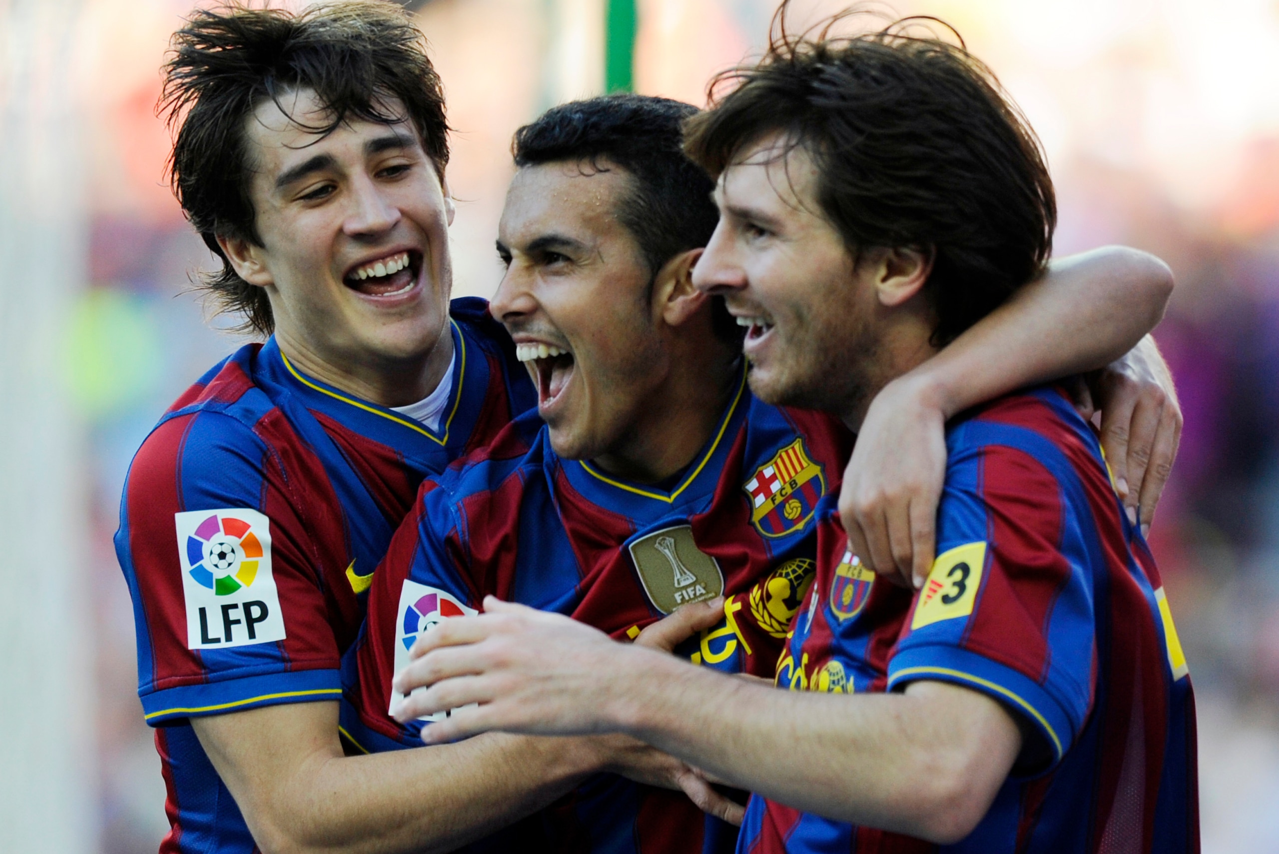 Barcelona's forward Pedro Rodriguez (C) celebrates with teammatesArgentinian forward Lionel Messi (R) and forward Bojan Krkic (L) after scoring during the Spanish League football match between Baqrcelona and Valladolid at Camp Nou stadium in Barcelona on 