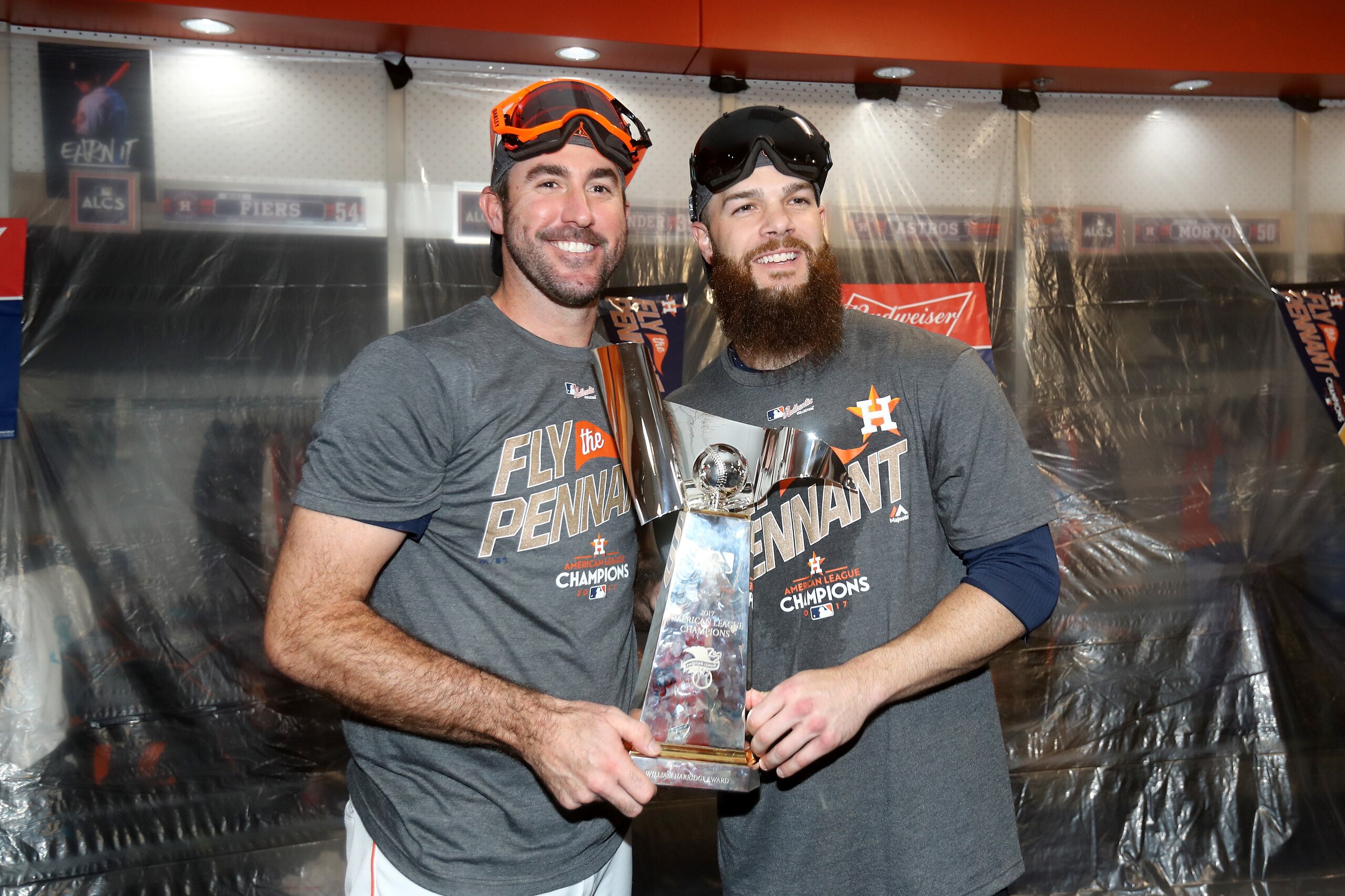 HOUSTON, TX - OCTOBER 21:  Justin Verlander #35 and Dallas Keuchel #60 of the Houston Astros celebrate with the William Harridge Trophy in the locker room after defeating the New York Yankees by a score of 4-0 to win Game Seven of the American League Cham
