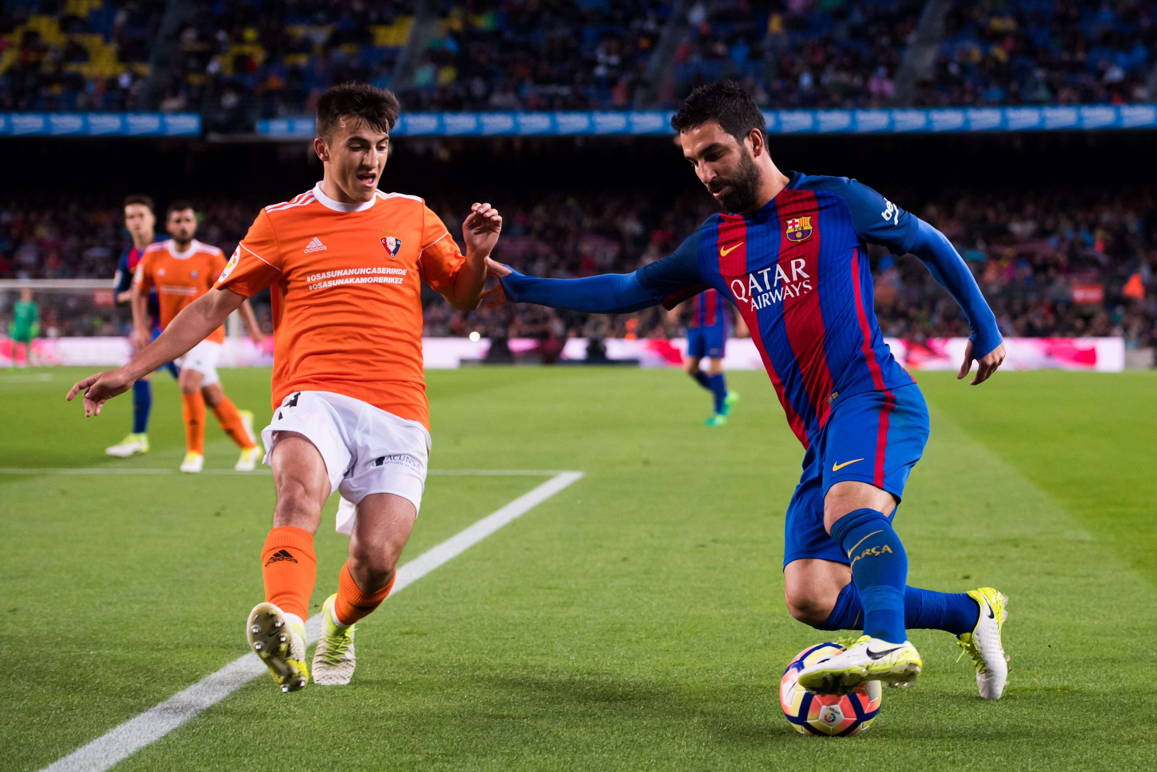BARCELONA, SPAIN - APRIL 26:  Arda Turan of FC Barcelona dribbles Aitor Bunuel of CA Osasuna during the La Liga match between FC Barcelona and CA Osasuna at Camp Nou stadium on April 26, 2017 in Barcelona, Spain.  (Photo by Alex Caparros/Getty Images)