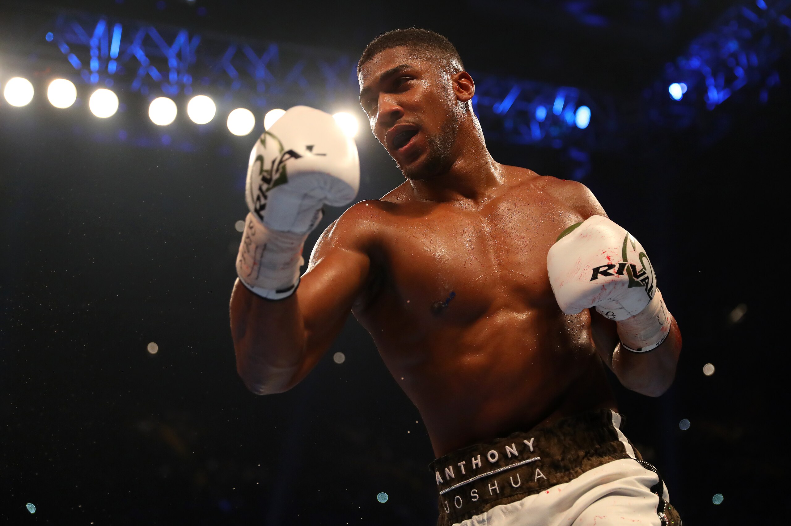 CARDIFF, WALES - OCTOBER 28:  Anthony Joshua (white trunks) and Carlos Takam (black trunks) in action during their IBF, WBA & IBO Heavyweight Championship contest at Principality Stadium on October 28, 2017 in Cardiff, Wales. (Photo by Richard Heathcote/G