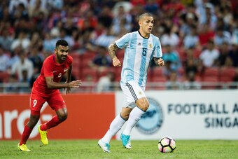SINGAPORE, SINGAPORE - JUNE 13: Leandro Paredes of Argentina (R) in action against Faritz Hameed of Singapore (L) during the International Test match between Argentina and Singapore at National Stadium on June 13, 2017 in Singapore. (Photo by Power Sport 