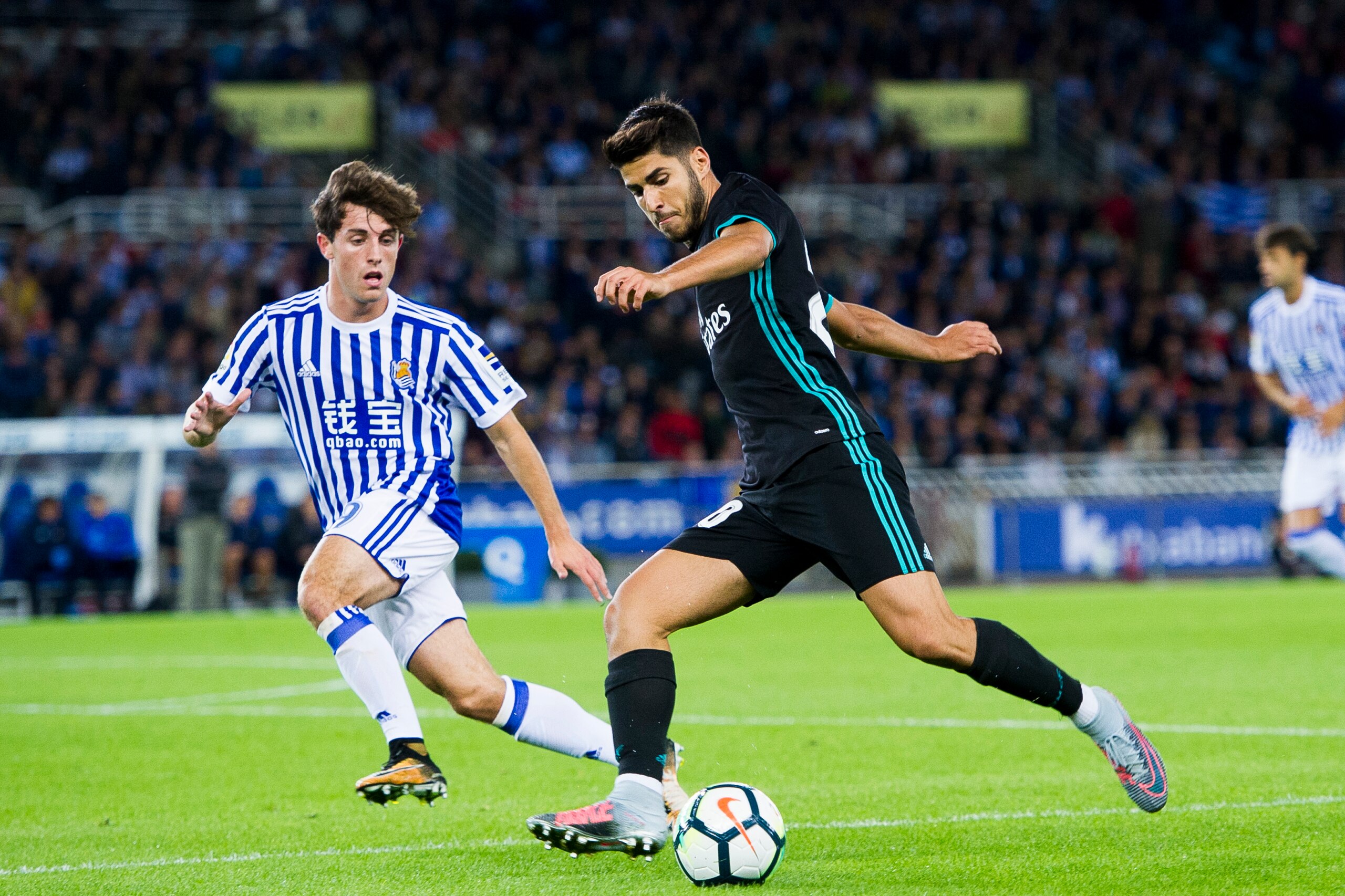 SAN SEBASTIAN, SPAIN - SEPTEMBER 17: Marco Asensio of Real Madrid duels for the ball with Alvaro Odriozola of Real Sociedad during the La Liga match between Real Sociedad de Futbol and Real Madrid at Estadio Anoeta on September 17, 2017 in San Sebastian, SAN SEBASTIAN, SPAIN - SEPTEMBER 17: Marco Asensio of Real Madrid duels for the ball with Alvaro Odriozola of Real Sociedad during the La Liga match between Real Sociedad de Futbol and Real Madrid at Estadio Anoeta on September 17, 2017 in San Sebastian,