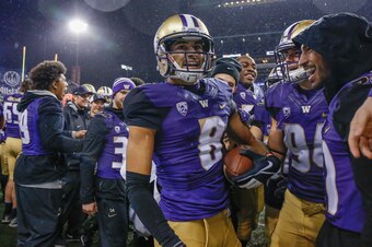 SEATTLE, WA - NOVEMBER 04:  Punt returner Dante Pettis #8 of the Washington Huskies is congratulated by teammates after returning a punt for a touchdown against the Oregon Ducks at Husky Stadium on November 4, 2017 in Seattle, Washington. The return for a