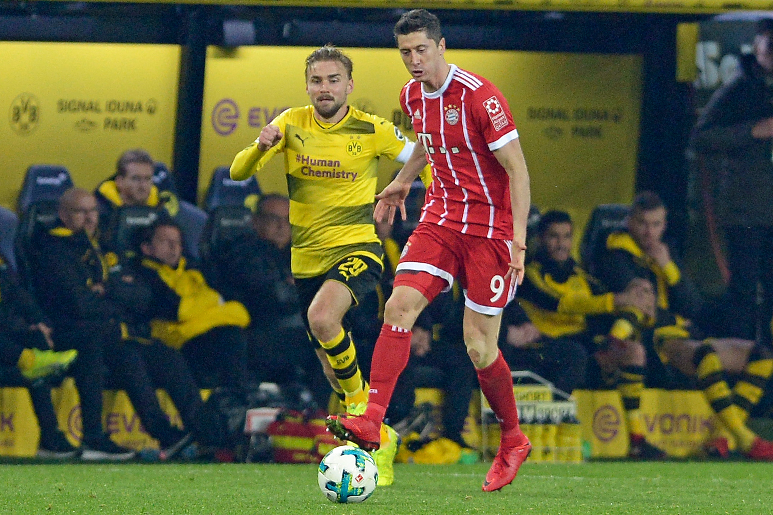 DORTMUND, GERMANY - NOVEMBER 4: Marcel Schmelzer of Dortmund and Robert Lewandowski of Bayern Muenchen battle for the ball during the German Bundesliga match between Borussia Dortmund v Bayern Munchen at the Signal Iduna Park on November 4, 2017 in Dortmu DORTMUND, GERMANY - NOVEMBER 4: Marcel Schmelzer of Dortmund and Robert Lewandowski of Bayern Muenchen battle for the ball during the German Bundesliga match between Borussia Dortmund v Bayern Munchen at the Signal Iduna Park on November 4, 2017 in Dortmu