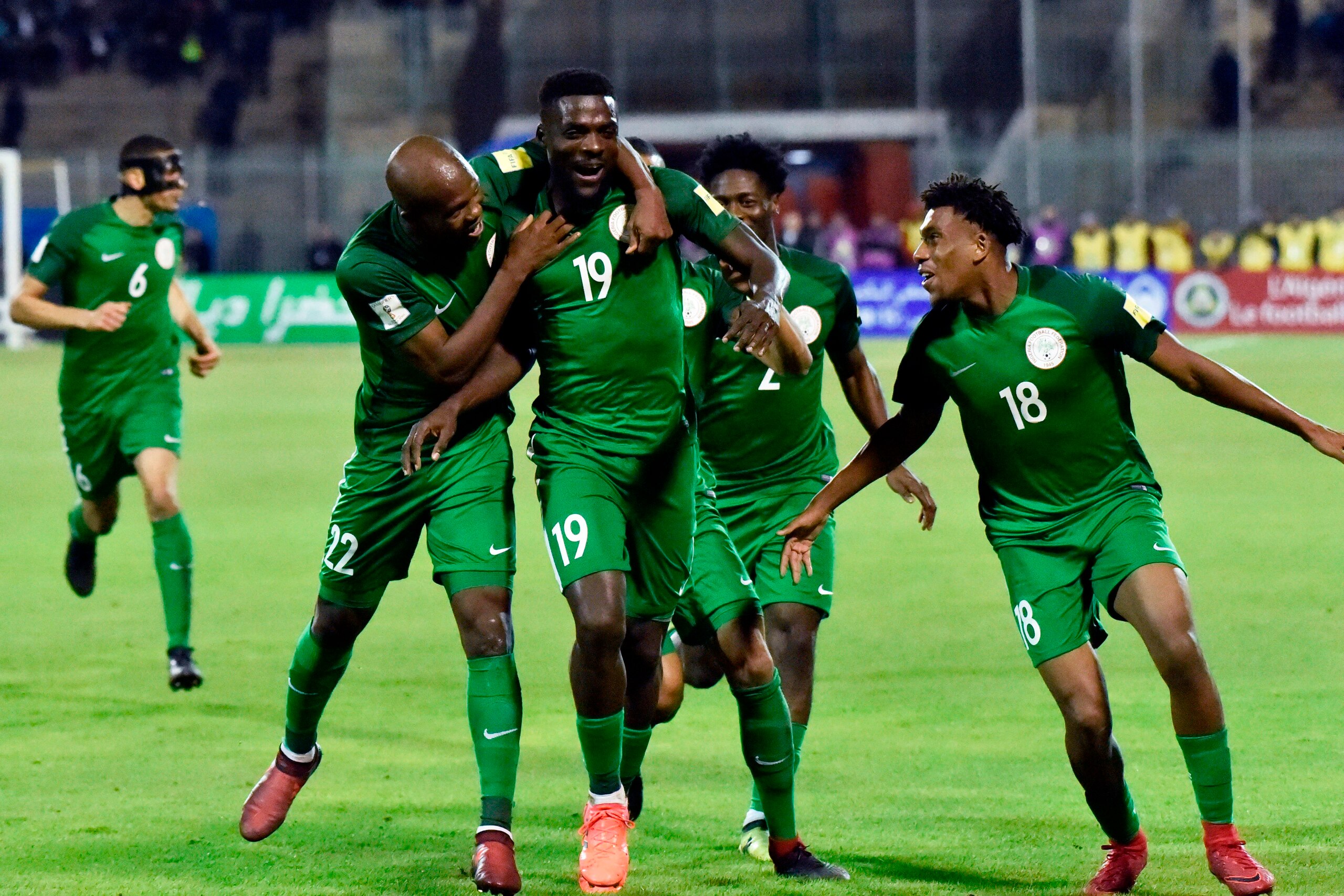 Nigeria's John Ogu (C) celebrates with teammates  after scoring a goal  during the 2018 FIFA World Cup Group B qualifying football match between Algeria and Nigeria at the Chahid Hamlaou Stadium in Constantine on November 10, 2017. / AFP PHOTO / RYAD KRAM