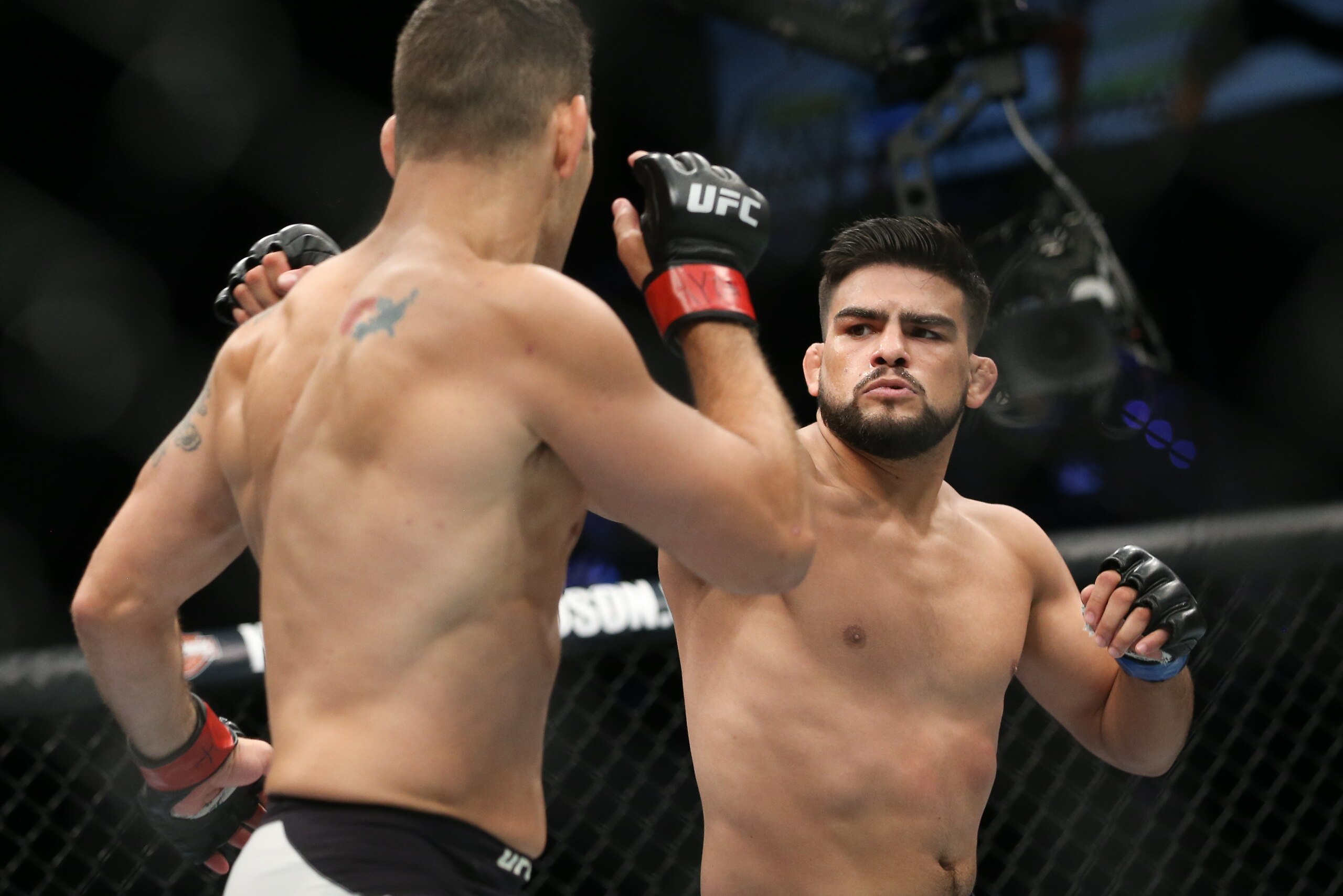 UNIONDALE, NY - JULY 22: Chris Weidman (L) and Kelvin Gastelum (R) trade punches during their UFC Fight Night middleweight bout at the Nassau Veterans Memorial Coliseum on July 22, 2017 in Uniondale, New York. (Photo by Ed Mulholland/Getty Images)