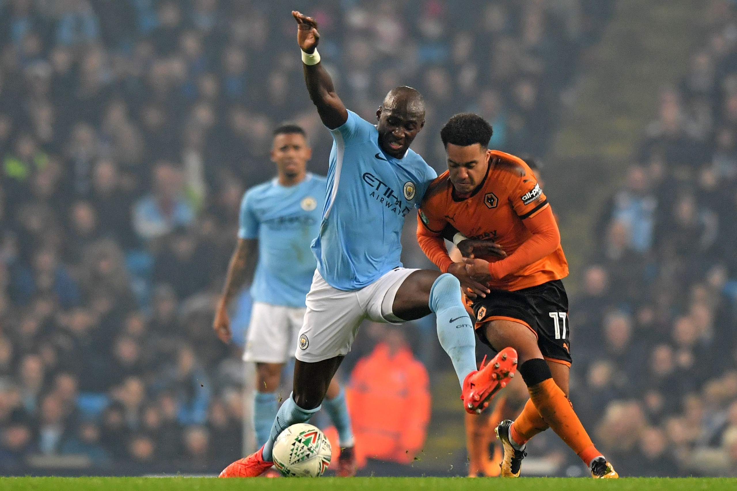 Wolverhampton Wanderers' Portuguese striker Helder Costa (R) vie with Manchester City's French defender Eliaquim Mangala during the English League Cup fourth round football match between Manchester City and Wolverhampton Wanderers at the Etihad Stadium in