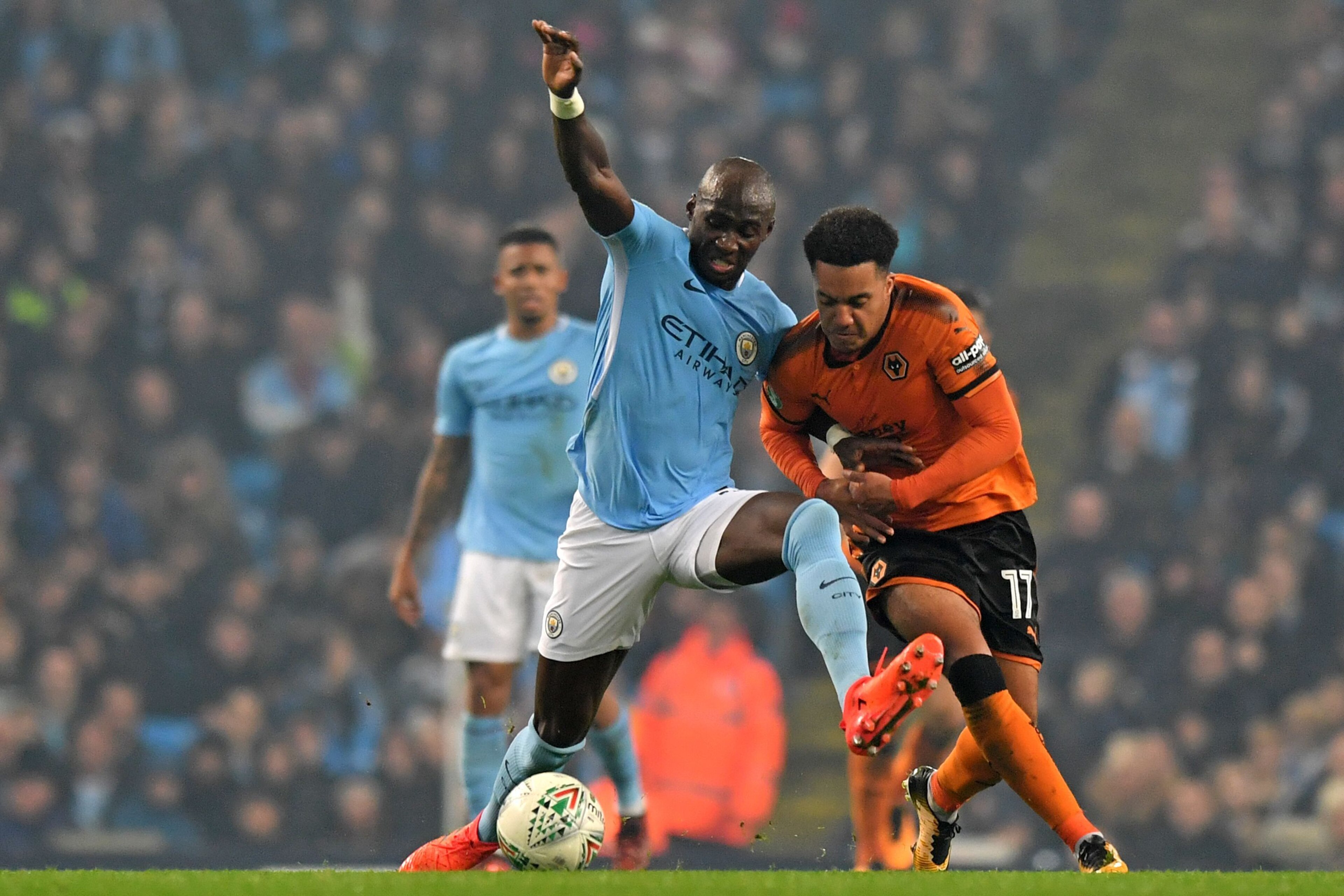 Wolverhampton Wanderers' Portuguese striker Helder Costa (R) vie with Manchester City's French defender Eliaquim Mangala during the English League Cup fourth round football match between Manchester City and Wolverhampton Wanderers at the Etihad Stadium in