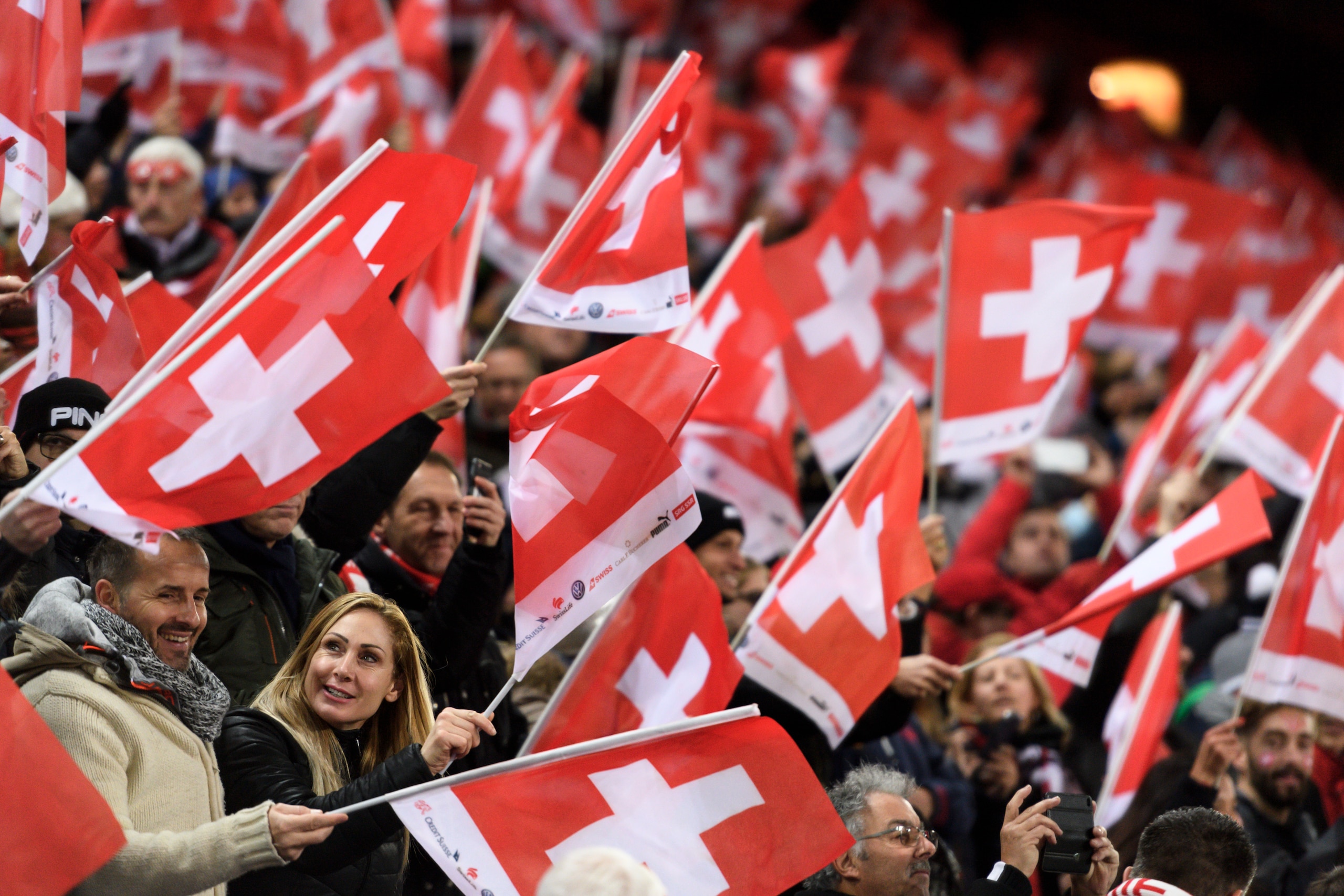 Supporters wave Swiss flags prior to the  FIFA 2018 World Cup play-off second leg qualifiying football match between Switzerland and Northern Ireland at St Jakob-Park Stadium on November 12, 2017. / AFP PHOTO / Fabrice COFFRINI        (Photo credit should