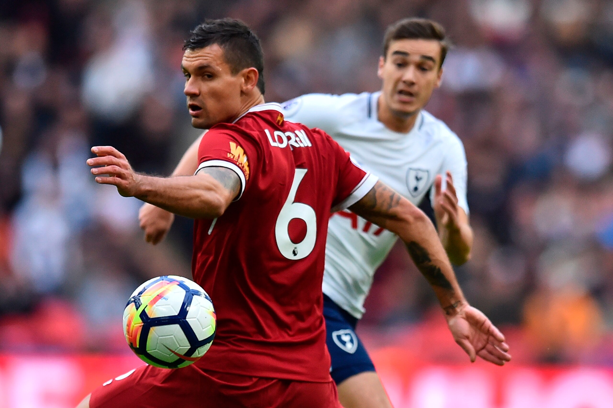 Tottenham Hotspur's English midfielder Harry Winks (R) passes past Liverpool's Croatian defender Dejan Lovren during the English Premier League football match between Tottenham Hotspur and Liverpool at Wembley Stadium in London, on October 22, 2017. / AFP Tottenham Hotspur's English midfielder Harry Winks (R) passes past Liverpool's Croatian defender Dejan Lovren during the English Premier League football match between Tottenham Hotspur and Liverpool at Wembley Stadium in London, on October 22, 2017. / AFP