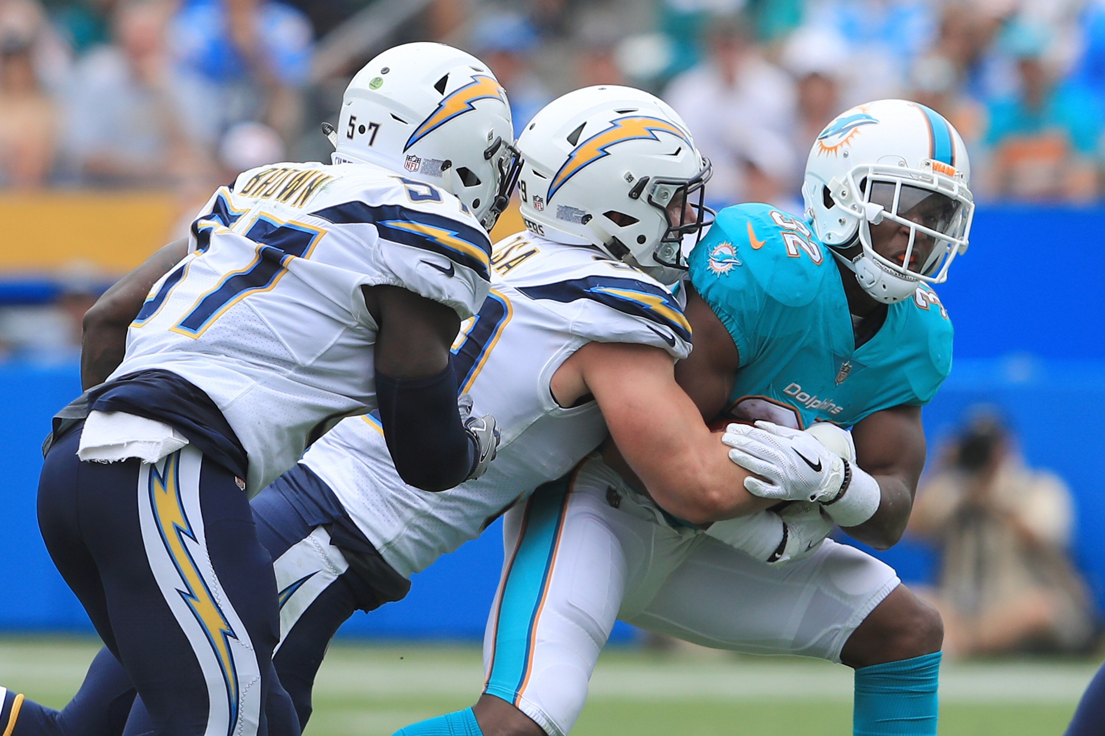 CARSON, CA - SEPTEMBER 17:  Joey Bosa #99 of the Los Angeles Chargers tackles Kenyan Drake #32 of the Miami Dolphins during the the first half of the NFL game at the StubHub Center on September 17, 2017 in Carson, California.  (Photo by Sean M. Haffey/Get