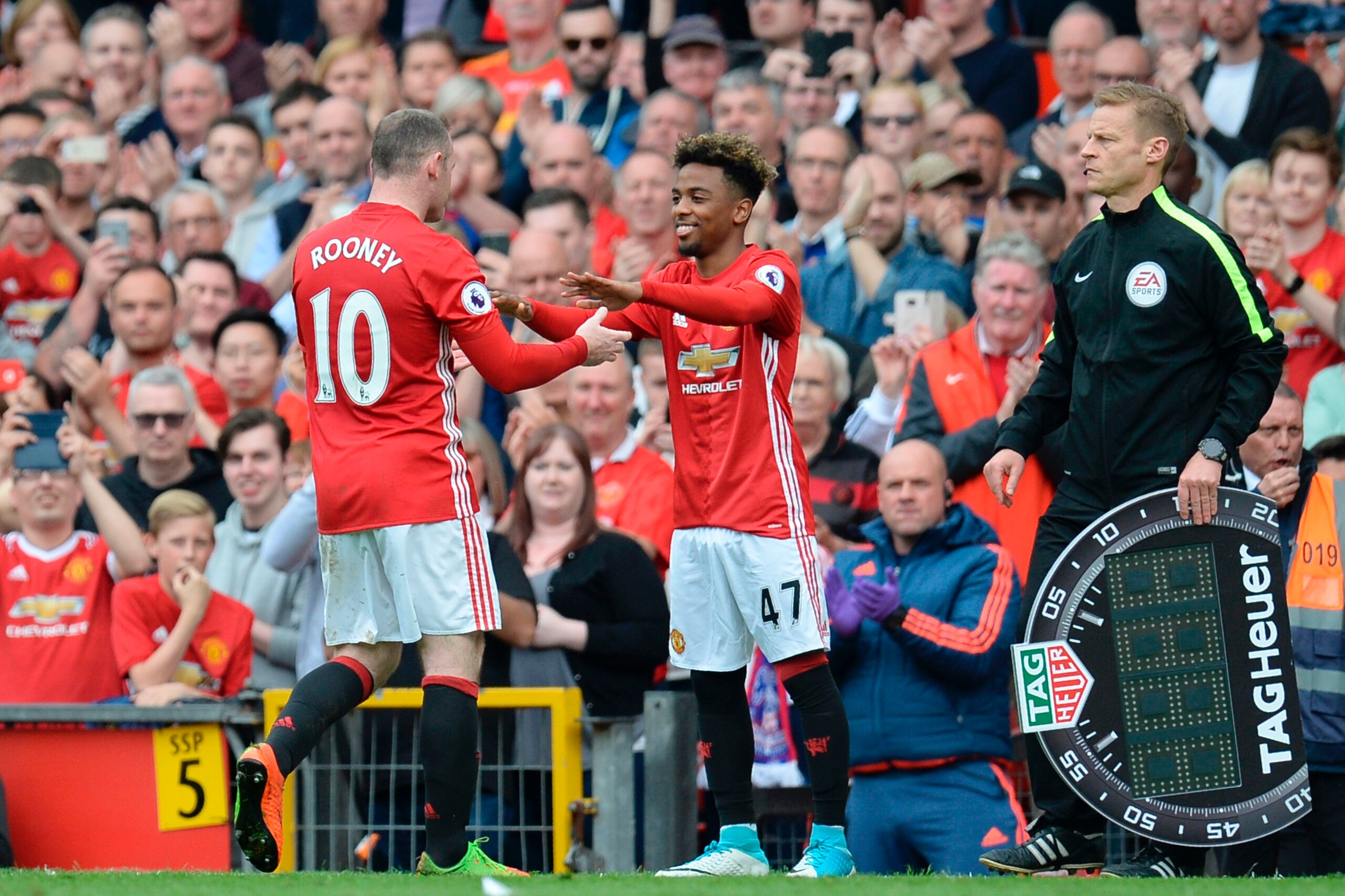 Manchester United's English striker Wayne Rooney (L) is substituted for Manchester United's English midfielder Angel Gomes (R) during the English Premier League football match between Manchester United and Cyrstal Palace at Old Trafford in Manchester, nor