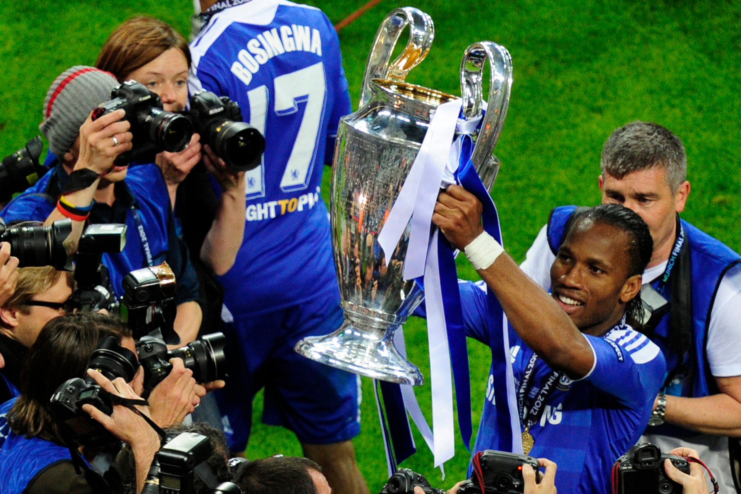 Chelsea's Ivorian forward Didier Drogba (R) celebrates with the trophy after the UEFA Champions League final football match between FC Bayern Muenchen and Chelsea FC on May 19, 2012 at the Fussball Arena stadium in Munich. Chelsea beat Bayern Munich 4-3 o