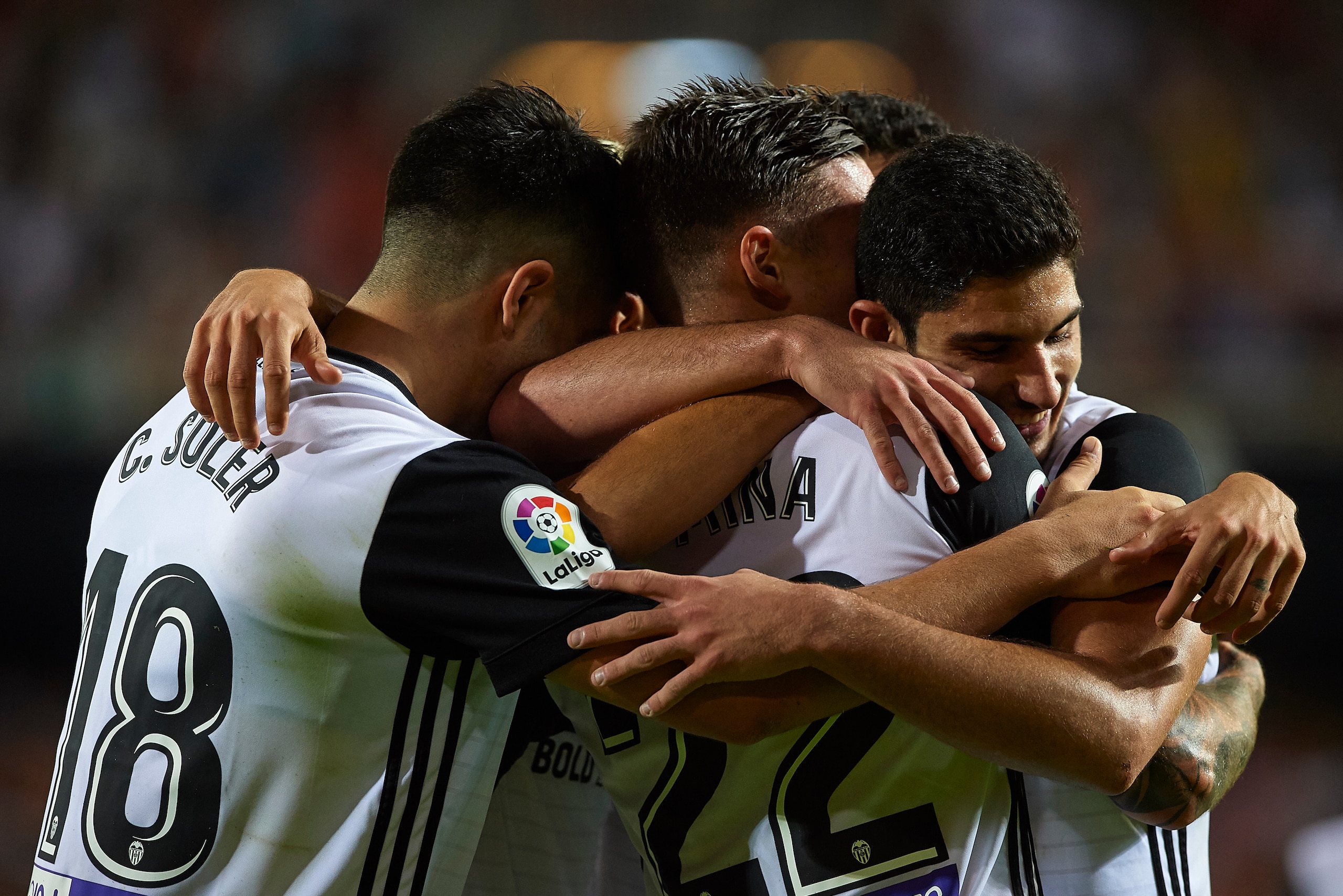 VALENCIA, SPAIN - OCTOBER 21:  Santi Mina of Valencia celebrates scoring his team's third goal with his teammates Goncalo Guedes (R) and Carlos Soler  during the La Liga match between Valencia and Sevilla at Estadio Mestalla on October 21, 2017 in Valenci