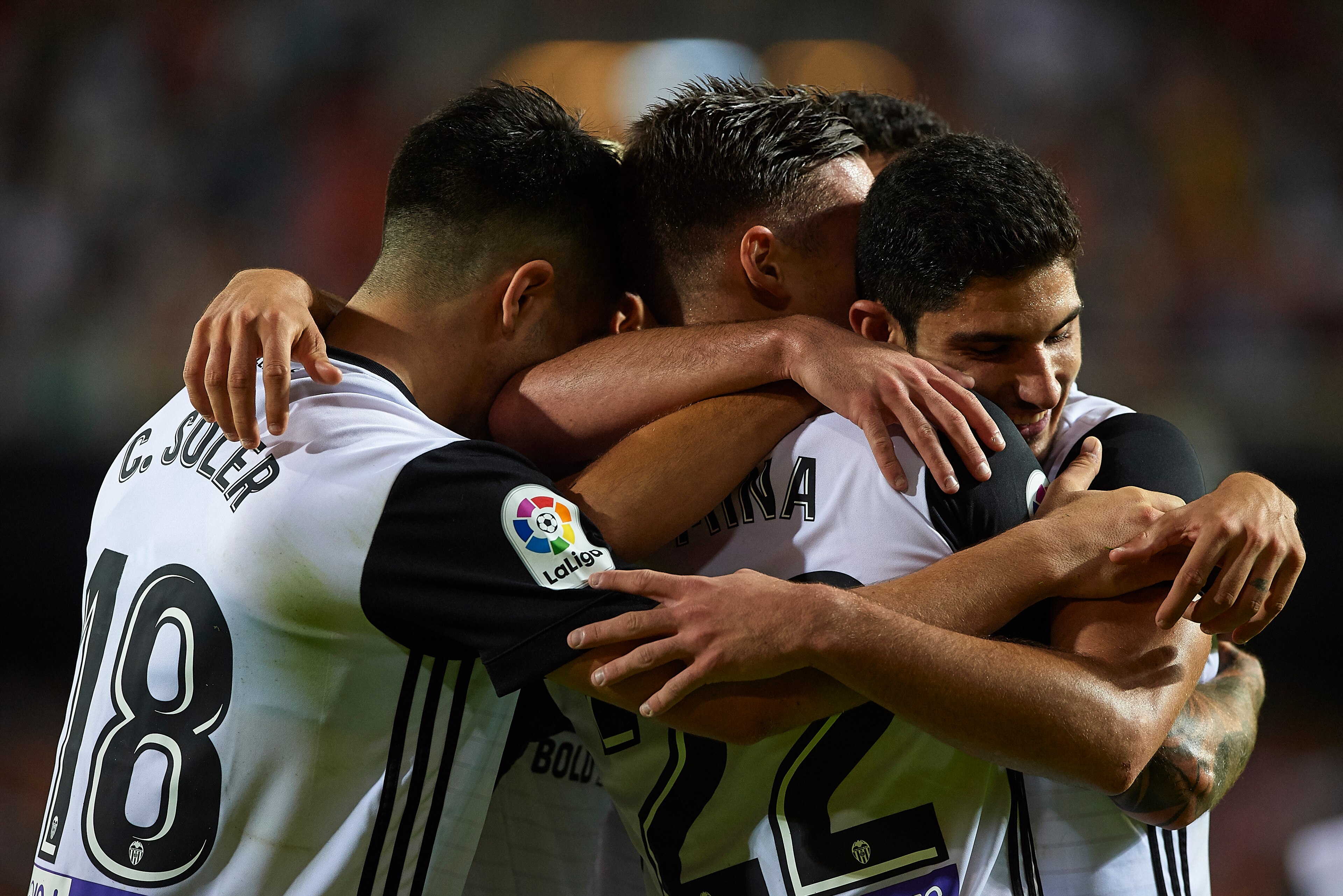 VALENCIA, SPAIN - OCTOBER 21:  Santi Mina of Valencia celebrates scoring his team's third goal with his teammates Goncalo Guedes (R) and Carlos Soler  during the La Liga match between Valencia and Sevilla at Estadio Mestalla on October 21, 2017 in Valenci