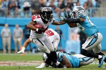CHARLOTTE, NC - NOVEMBER 05: Devonta Freeman #24 of the Atlanta Falcons runs the ball against Mike Adams #29 of the Carolina Panthers in the fourth quarter during their game at Bank of America Stadium on November 5, 2017 in Charlotte, North Carolina.  (Ph