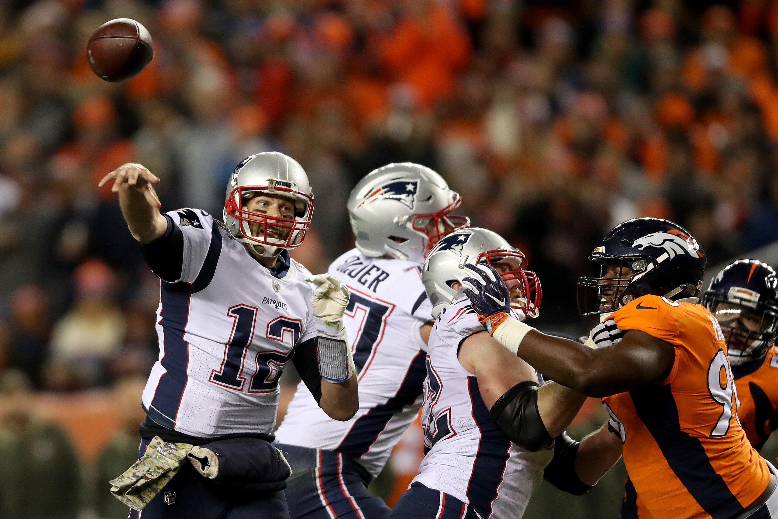 DENVER, CO - NOVEMBER 12:  Quarterback Tom Brady #12 of the New England Patriots throws against the Denver Broncos at Sports Authority Field at Mile High on November 12, 2017 in Denver, Colorado.  (Photo by Matthew Stockman/Getty Images)