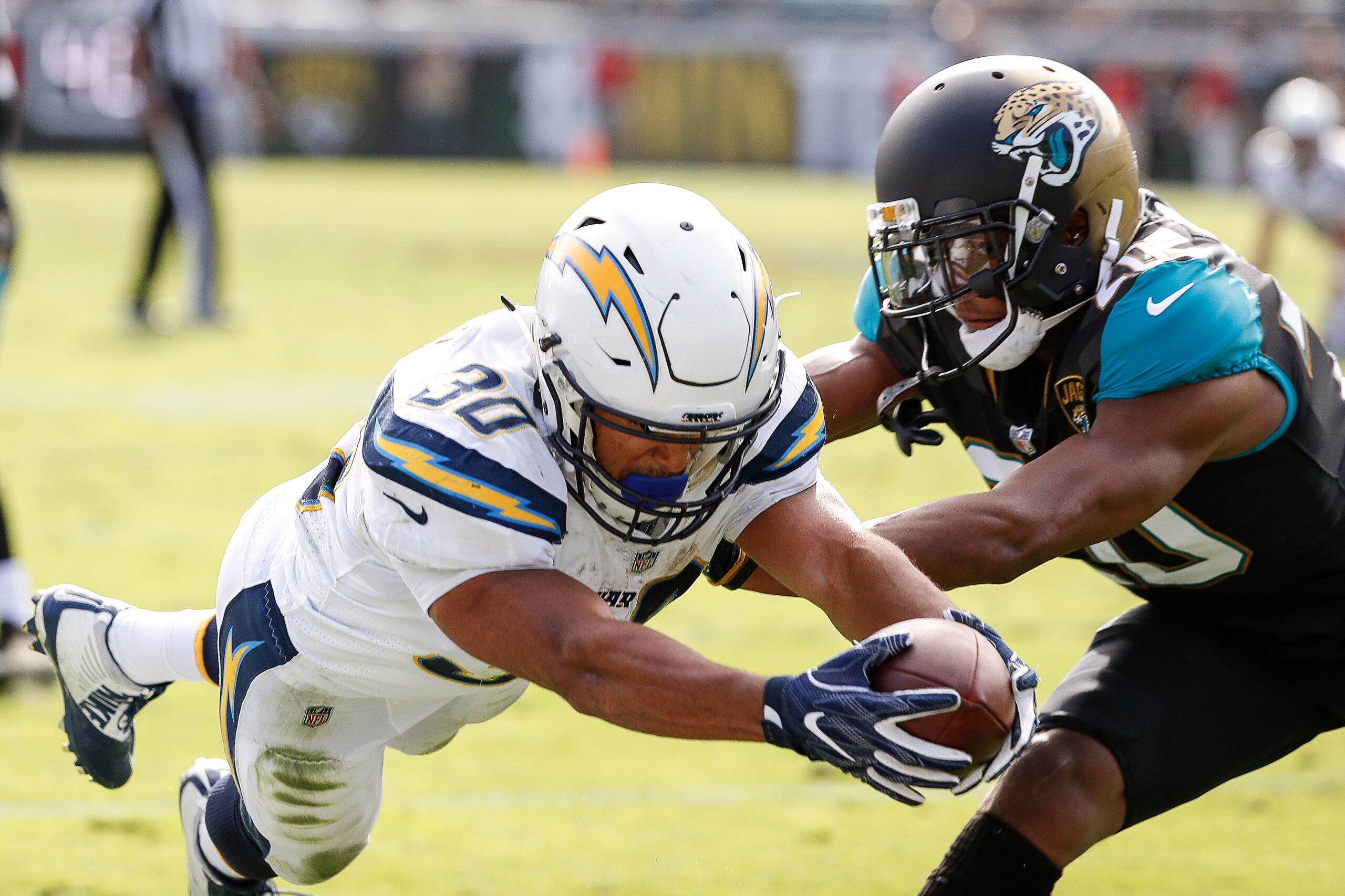 JACKSONVILLE, FL - NOVEMBER 12: Runningback Austin Ekeler #30 of the Los Angeles Chargers dives in for a score over Cornerback Jalen Ramsey #20 of the Jacksonville Jaguars during the game at EverBank Field on November 12, 2017 in Jacksonville, Florida. Th