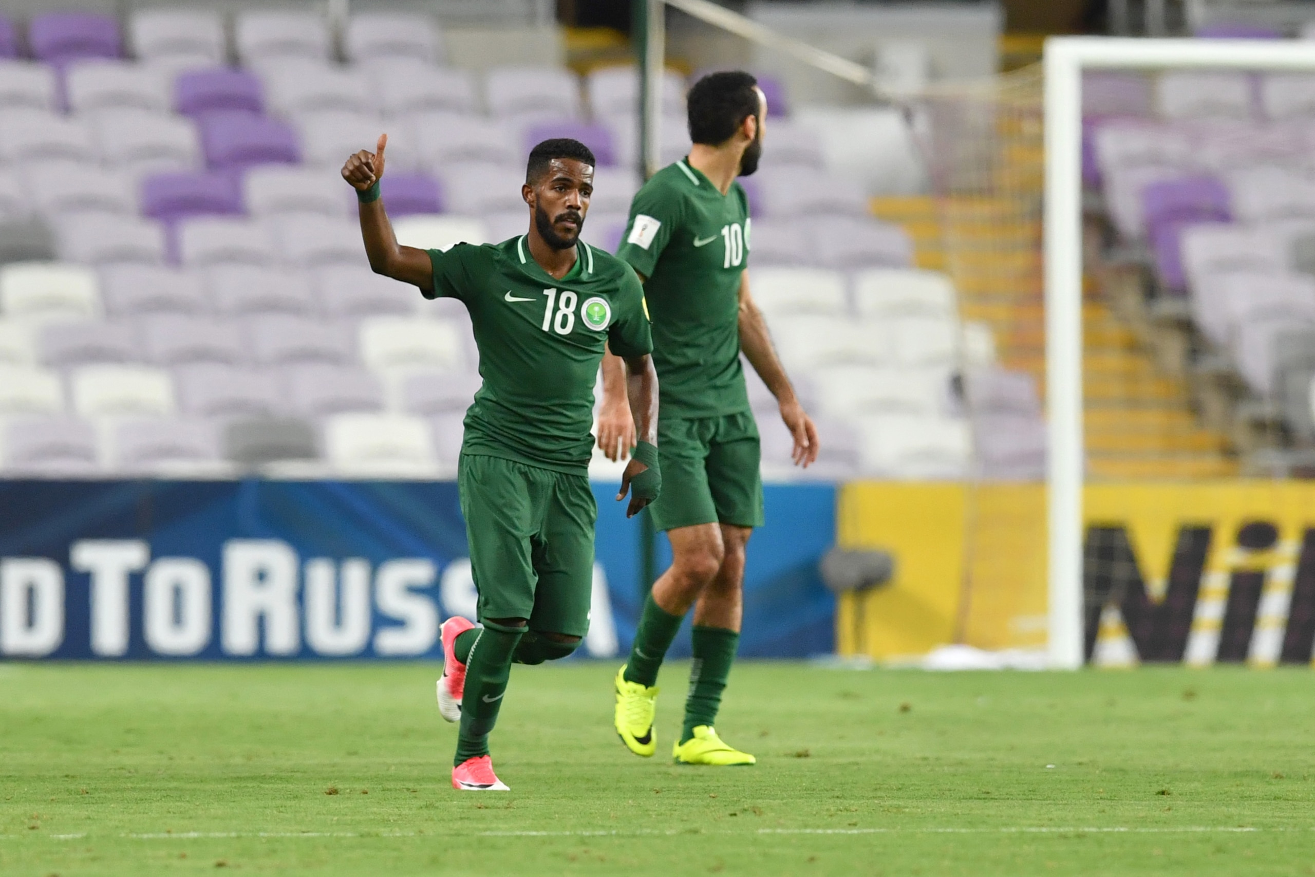Saudi's midfielder Nawaf Al-Abid (R) celebrates scoring a penalty during the 2018 FIFA World Cup qualifier football match between UAE and Saudi Arabia at the Hazza Bin Zayed Stadium in Al-Ain on August 29, 2017. / AFP PHOTO / GIUSEPPE CACACE (Photo Saudi's midfielder Nawaf Al-Abid (R) celebrates scoring a penalty during the 2018 FIFA World Cup qualifier football match between UAE and Saudi Arabia at the Hazza Bin Zayed Stadium in Al-Ain on August 29, 2017. / AFP PHOTO / GIUSEPPE CACACE (Photo
