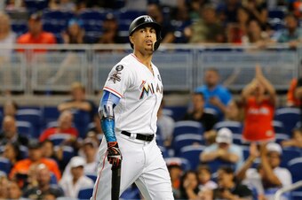 MIAMI, FL - OCTOBER 1:  Giancarlo Stanton #27 of the Miami Marlins walks to the dugout striking out in the ninth inning of play against the Atlanta Braves, ending his bid for 60 home runs for the season at Marlins Park on October 1, 2017 in Miami, Florida