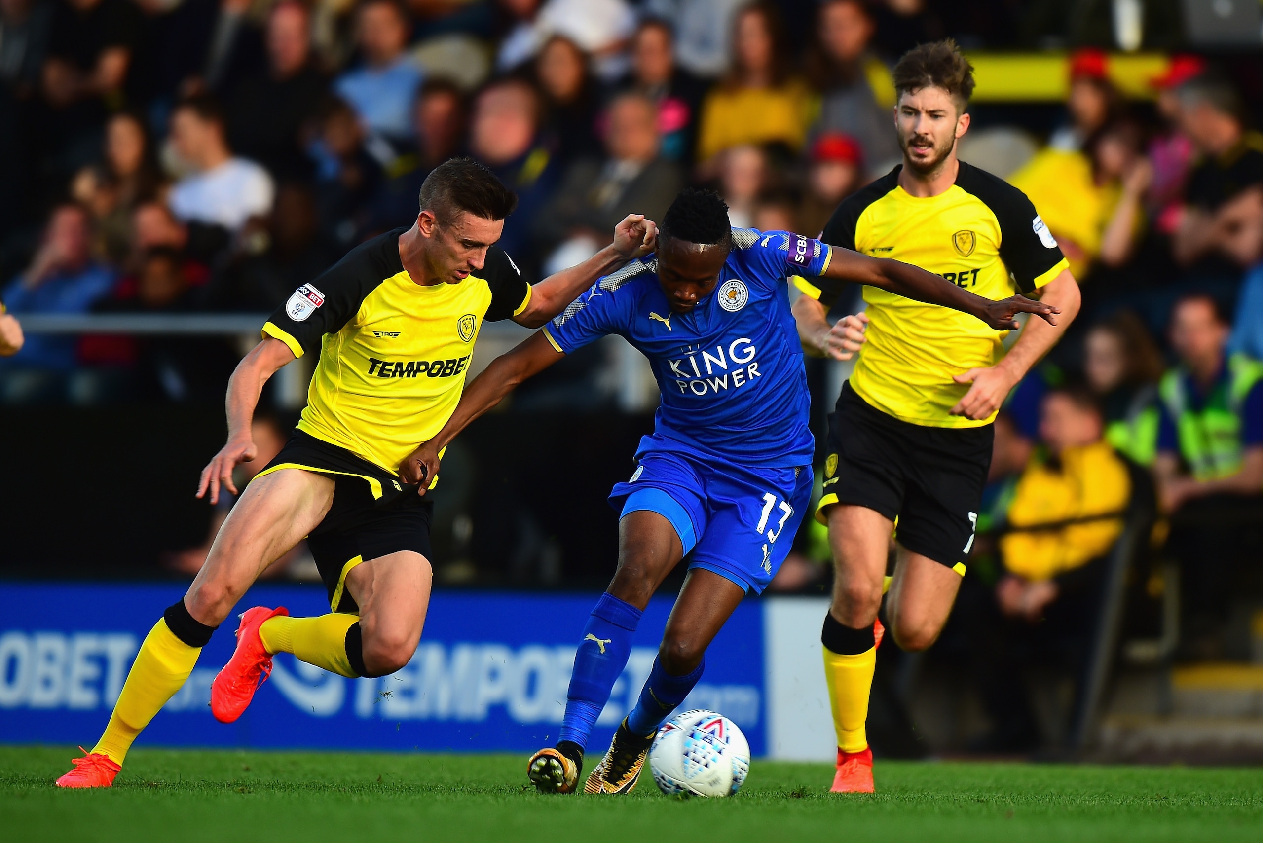 BURTON-UPON-TRENT, ENGLAND - AUGUST 01:  Ahmed Musa of Leicester City holds off a challenge from Matthew Lund of Burton Albion during the Pre-Season Friendly match between Burton Albion v Leicester City at Pirelli Stadium on August 1, 2017 in Burton-upon-