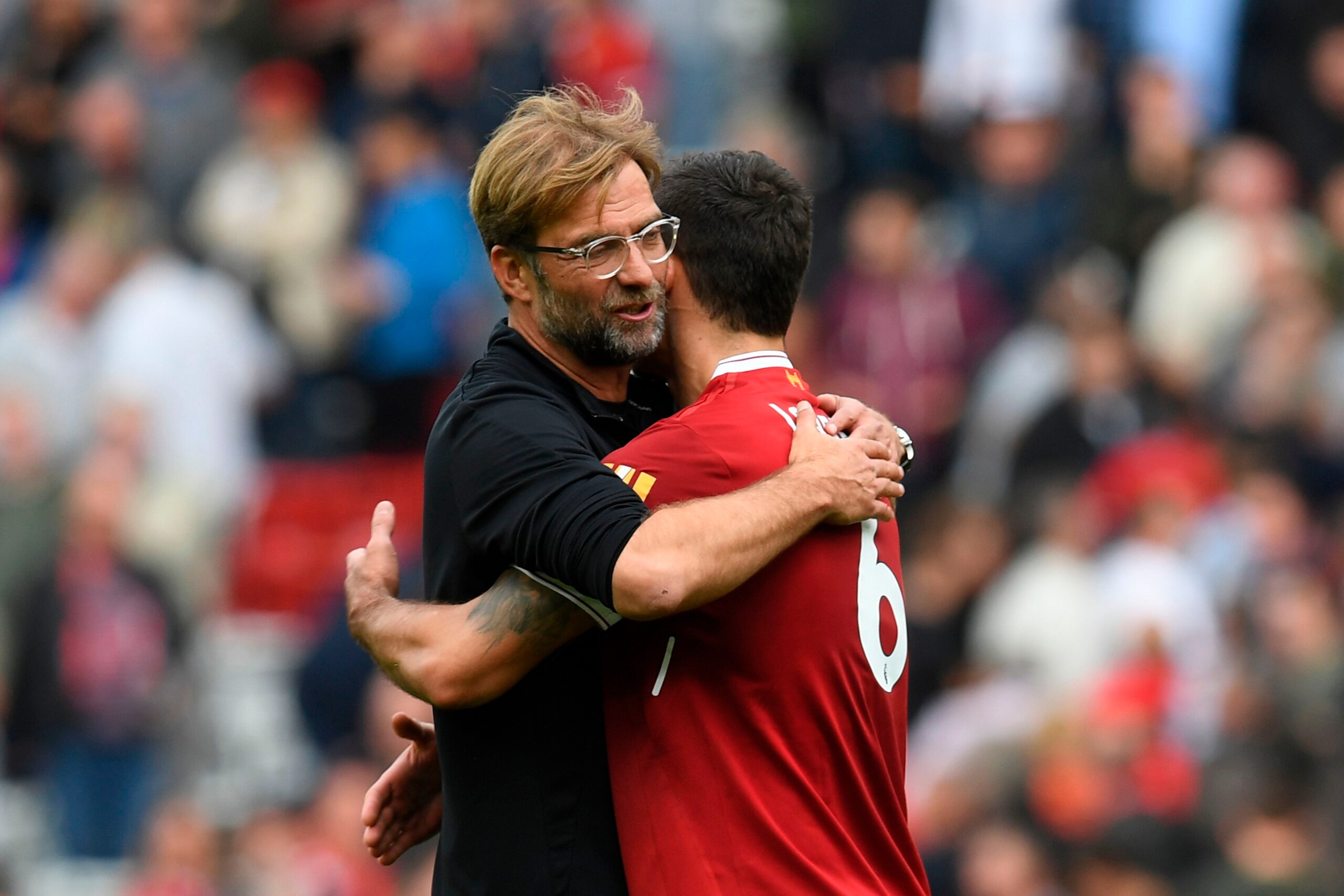 Liverpool's German manager Jurgen Klopp (L) embraces Liverpool's Croatian defender Dejan Lovren after the English Premier League football match between Liverpool and Manchester United at Anfield in Liverpool, north west England on October 14, 2017.
The ga