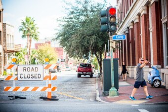 Pedestrians walk past the road closure outside the Contemporary Arts Museum, where Serena Williams will be getting married later this evening in New Orleans, Louisiana on November 16, 2017. / AFP PHOTO / Emily KASK        (Photo credit should read EMILY K