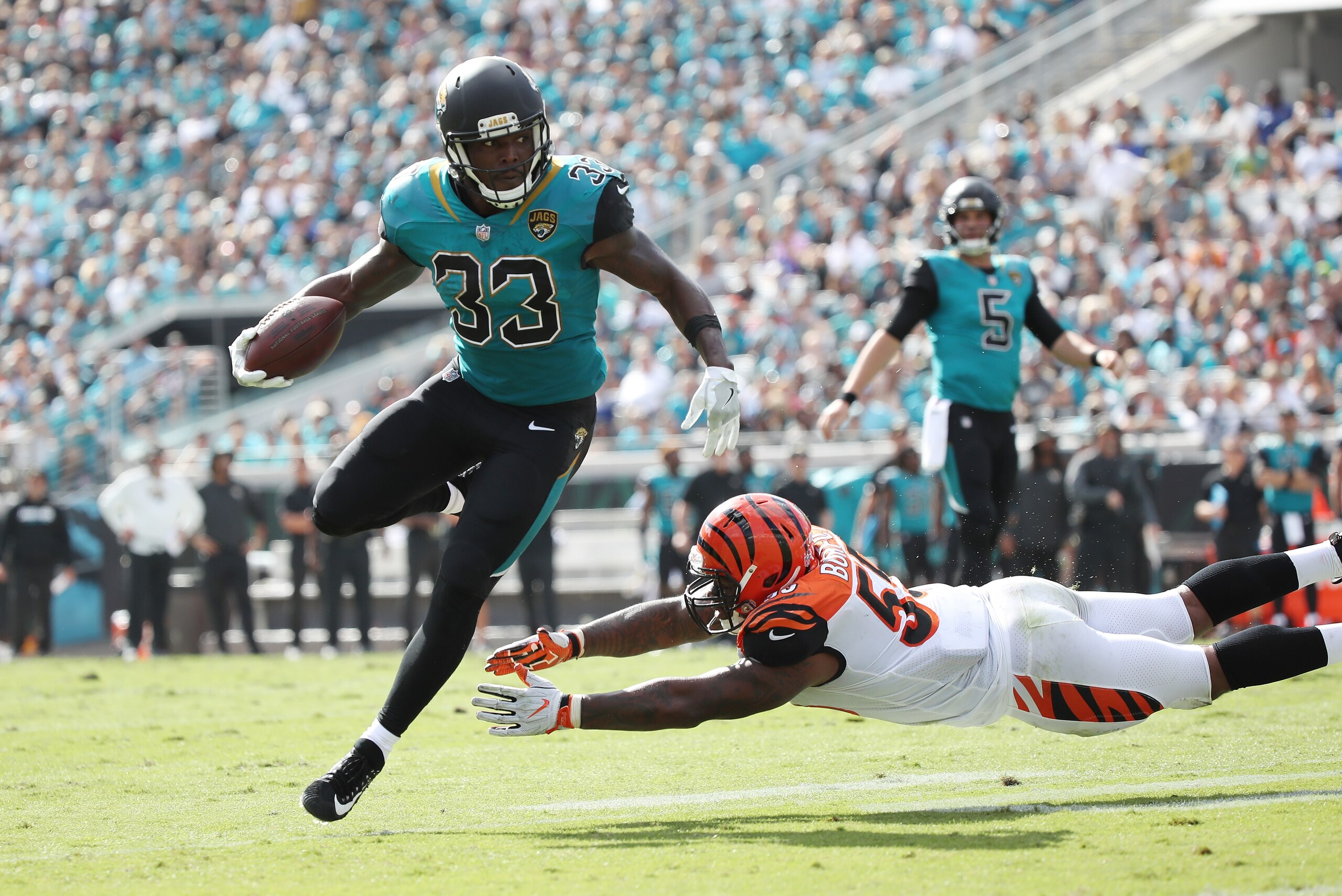 JACKSONVILLE, FL - NOVEMBER 05:   Chris Ivory #33 of the Jacksonville Jaguars runs with the football over  Vontaze Burfict #55 of the Cincinnati Bengals during the first half of their game at EverBank Field on November 5, 2017 in Jacksonville, Florida.  (