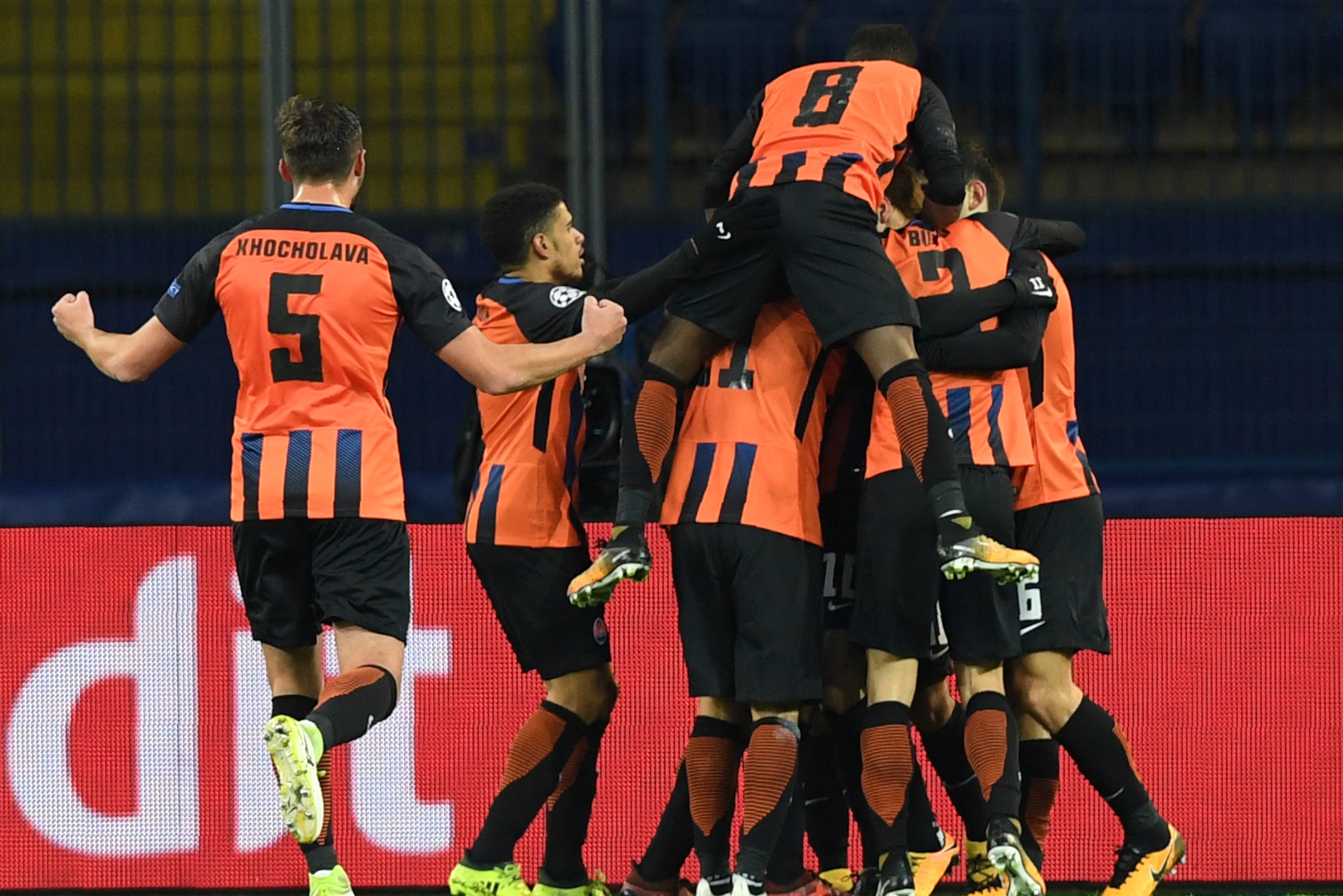 FC Shakhtar's players celebrate after scoring a goal during the UEFA Champions League Group F football match between FC Shakhtar Donetsk and Feyenoord at the Metalist stadium in Kharkiv on November 1, 2017. / AFP PHOTO / SERGEI SUPINSKY        (Photo cred
