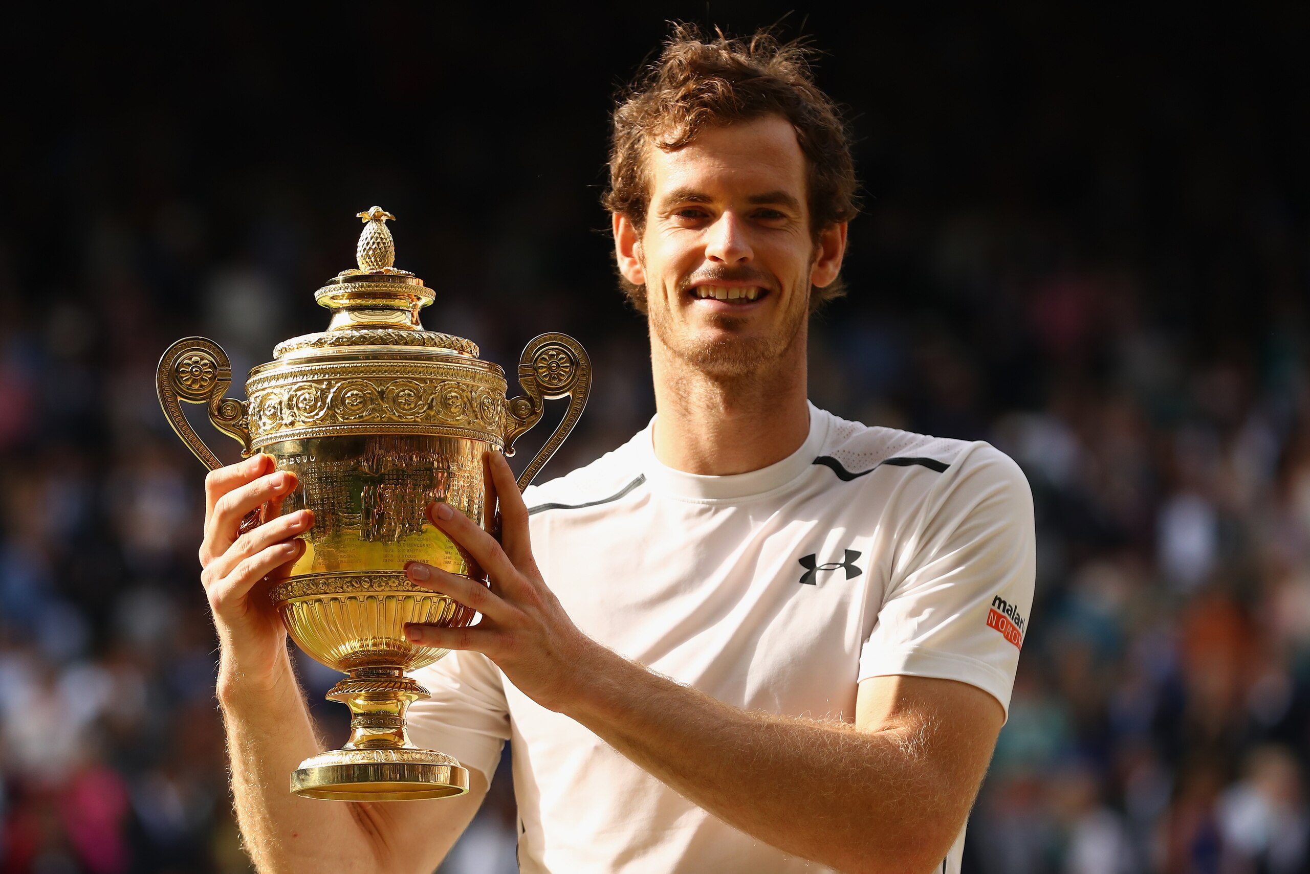 LONDON, ENGLAND - JULY 10:  Andy Murray of Great Britain lifts the trophy following victory in the Men's Singles Final against Milos Raonic of Canada on day thirteen of the Wimbledon Lawn Tennis Championships at the All England Lawn Tennis and Croquet Clu