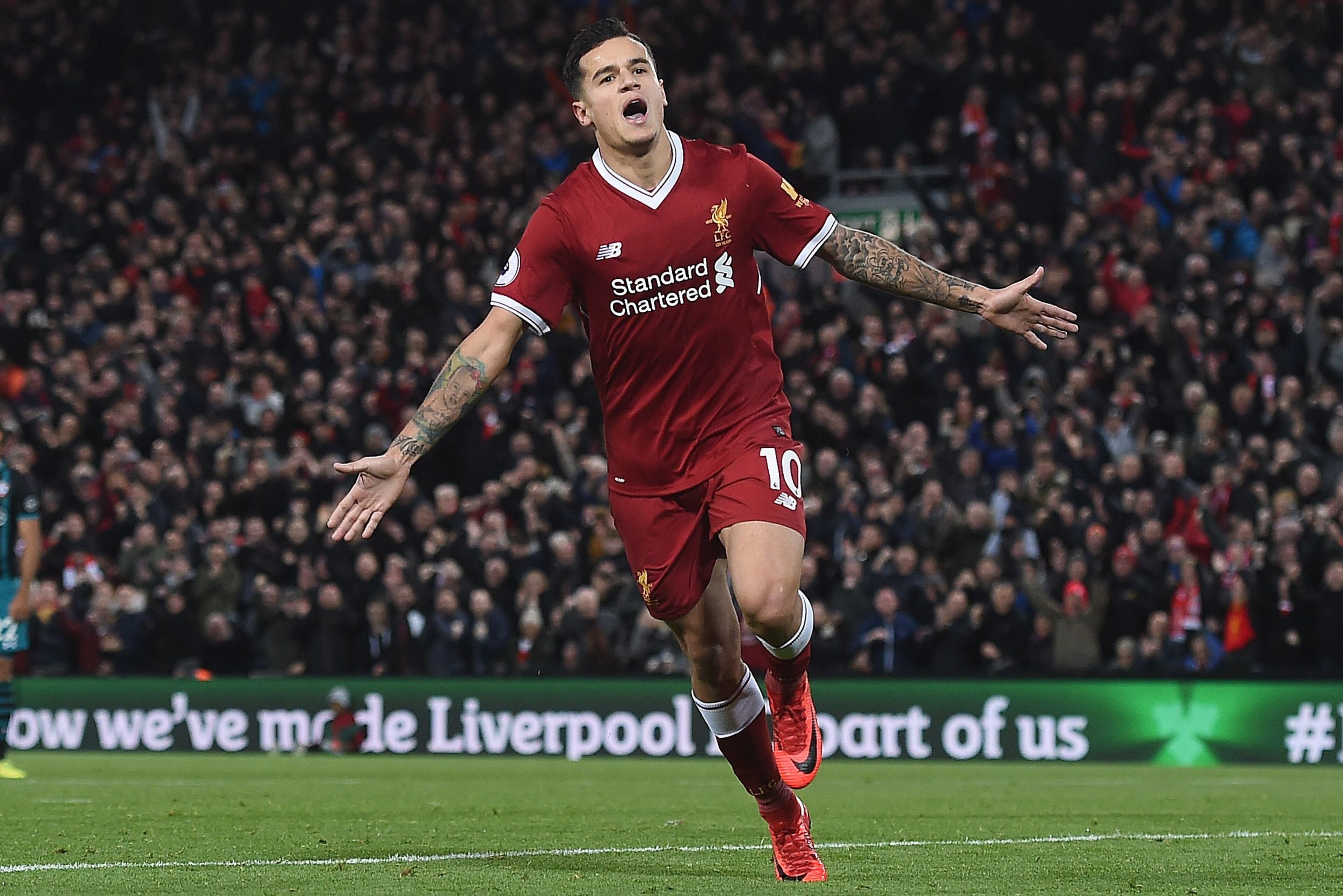 Liverpool's Brazilian midfielder Philippe Coutinho celebrates scoring his team's third goal during the English Premier League football match between Liverpool and Southampton at Anfield in Liverpool, north west England on November 18, 2017. / AFP PHOTO / 