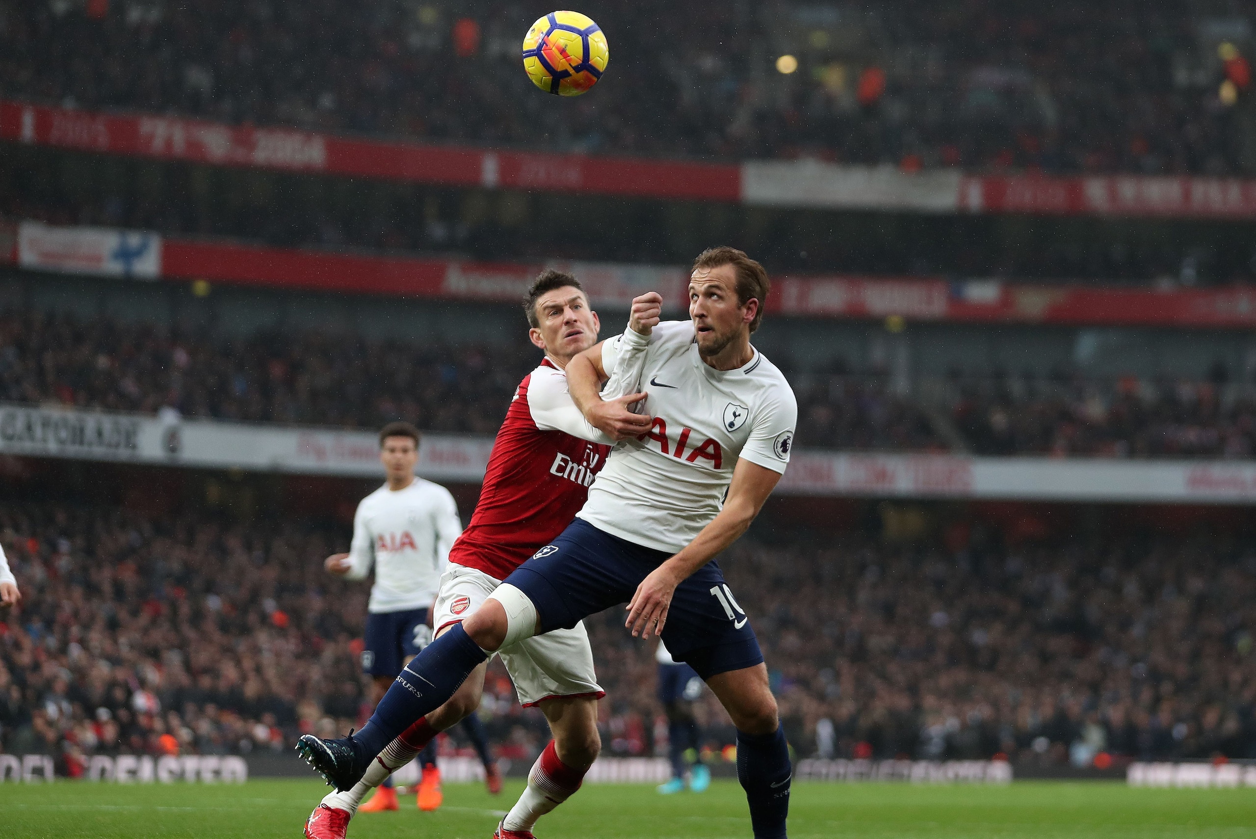 Arsenal's French defender Laurent Koscielny (L) vies with Tottenham Hotspur's English striker Harry Kane during the English Premier League football match between Arsenal and Tottenham Hotspur at the Emirates Stadium in London on November 18, 2017.  / AFP 