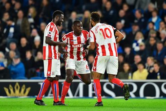Stoke City's German midfielder Eric Maxim Choupo-Moting (R) does a celebratory dance with Stoke City's French defender Kurt Zouma (C) after scoring the opening goal during the English Premier League football match between Brighton and Hove Albion and Stok