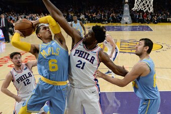 LOS ANGELES, CA - NOVEMBER 15:  Joel Embiid #21 of the Philadelphia 76ers defends against Jordan Clarkson #6 of the Los Angeles Lakers during the second half of the basketball game at Staples Center November 15, 2017, in Los Angeles, California. Embed sco