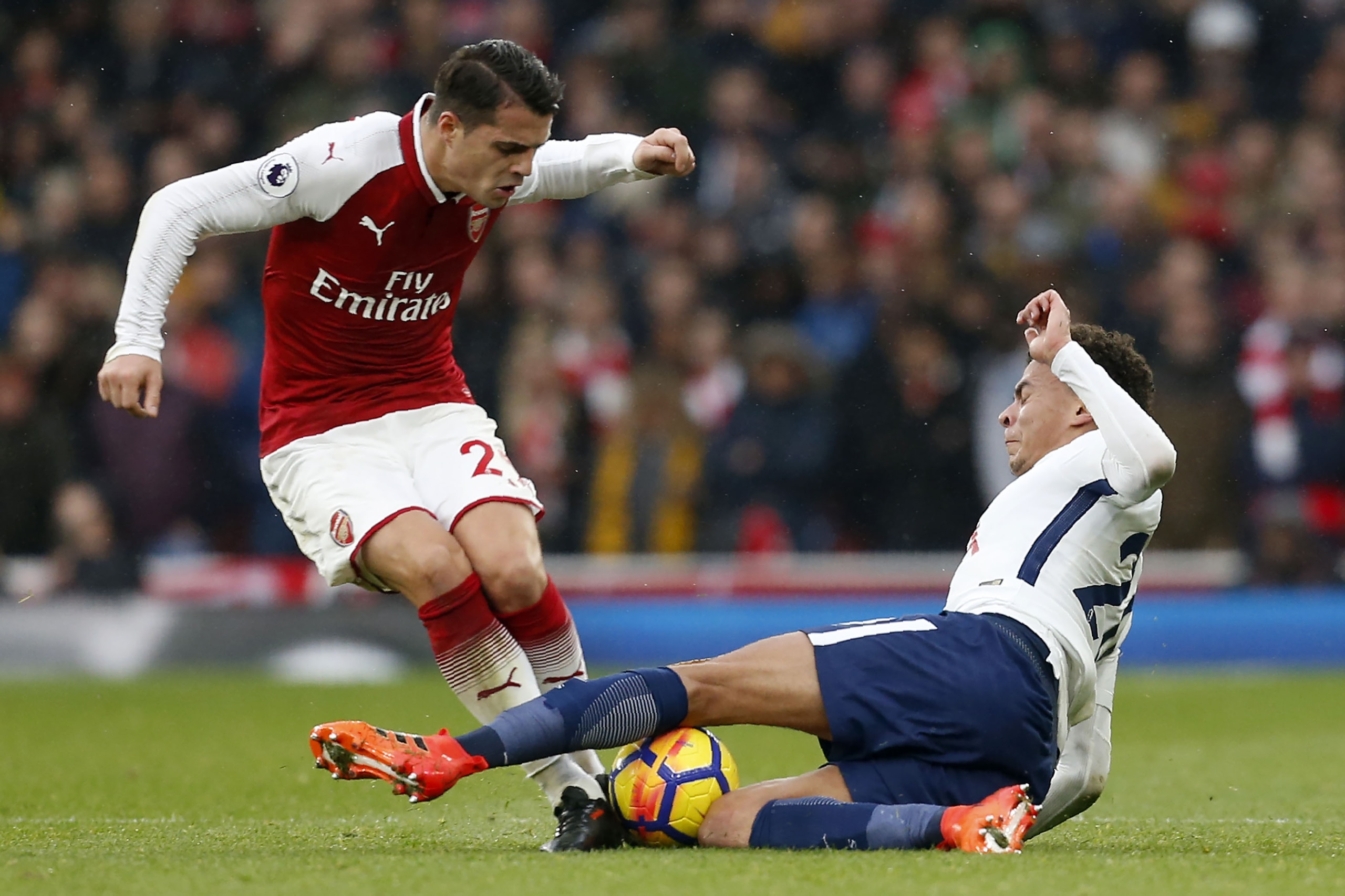 Tottenham Hotspur's English midfielder Dele Alli (R) tackles Arsenal's Swiss midfielder Granit Xhaka during the English Premier League football match between Arsenal and Tottenham Hotspur at the Emirates Stadium in London on November 18, 2017.  / AFP PHOT