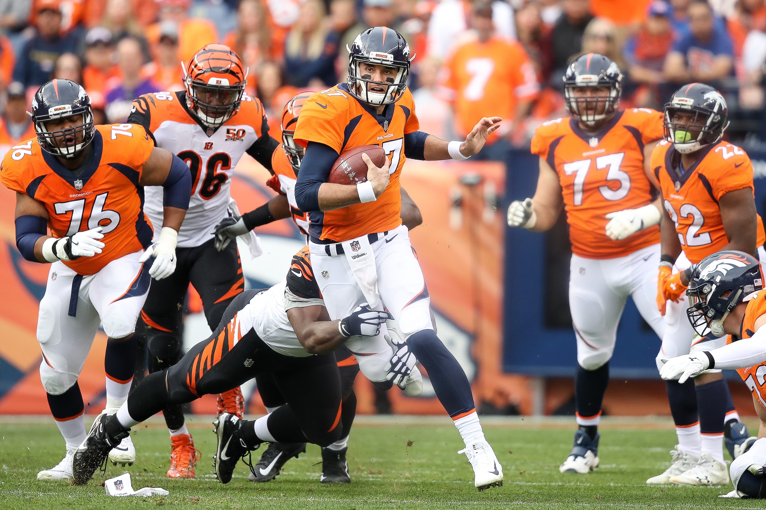 DENVER, CO - NOVEMBER 19: Quarterback Brock Osweiler #17 of the Denver Broncos rushes and is tackled by defensive tackle Geno Atkins #97 of the Cincinnati Bengals on a third down play in the first quarter of a game at Sports Authority Field at Mile High DENVER, CO - NOVEMBER 19: Quarterback Brock Osweiler #17 of the Denver Broncos rushes and is tackled by defensive tackle Geno Atkins #97 of the Cincinnati Bengals on a third down play in the first quarter of a game at Sports Authority Field at Mile High